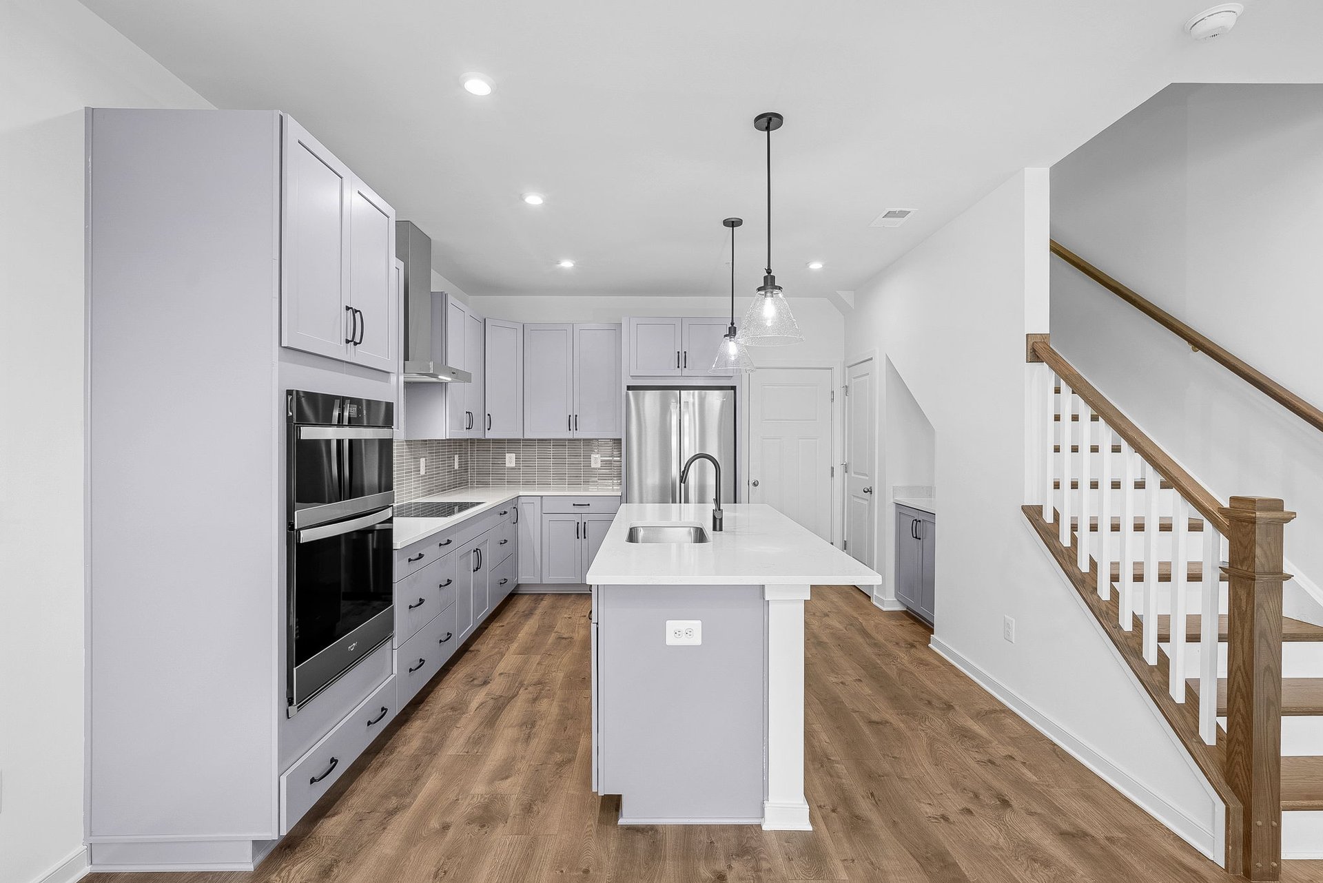 kitchen with gray cabinetry and hardwood floors