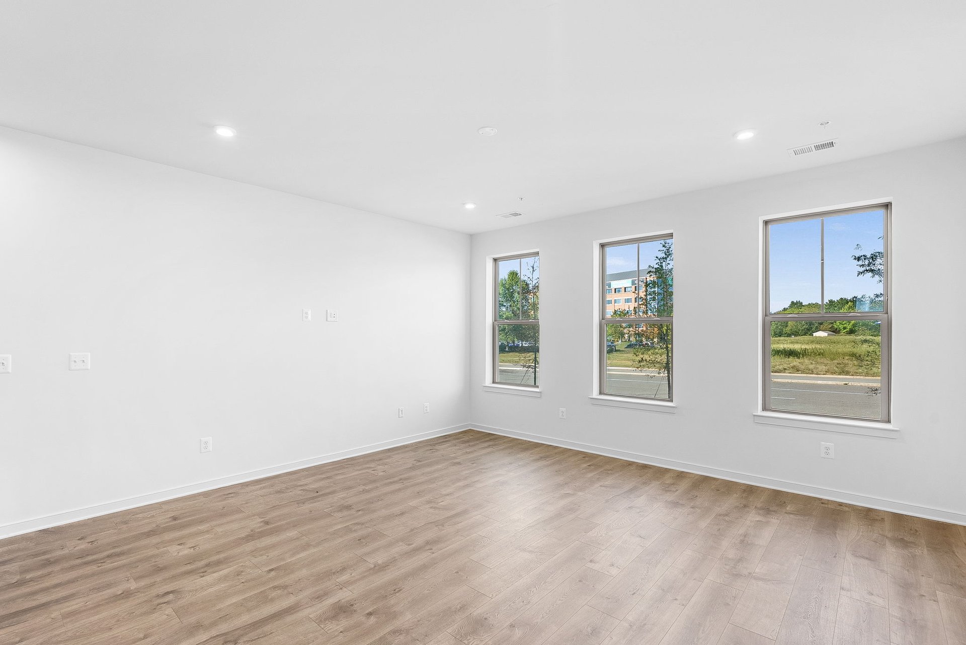 great room with windows and hardwood floors