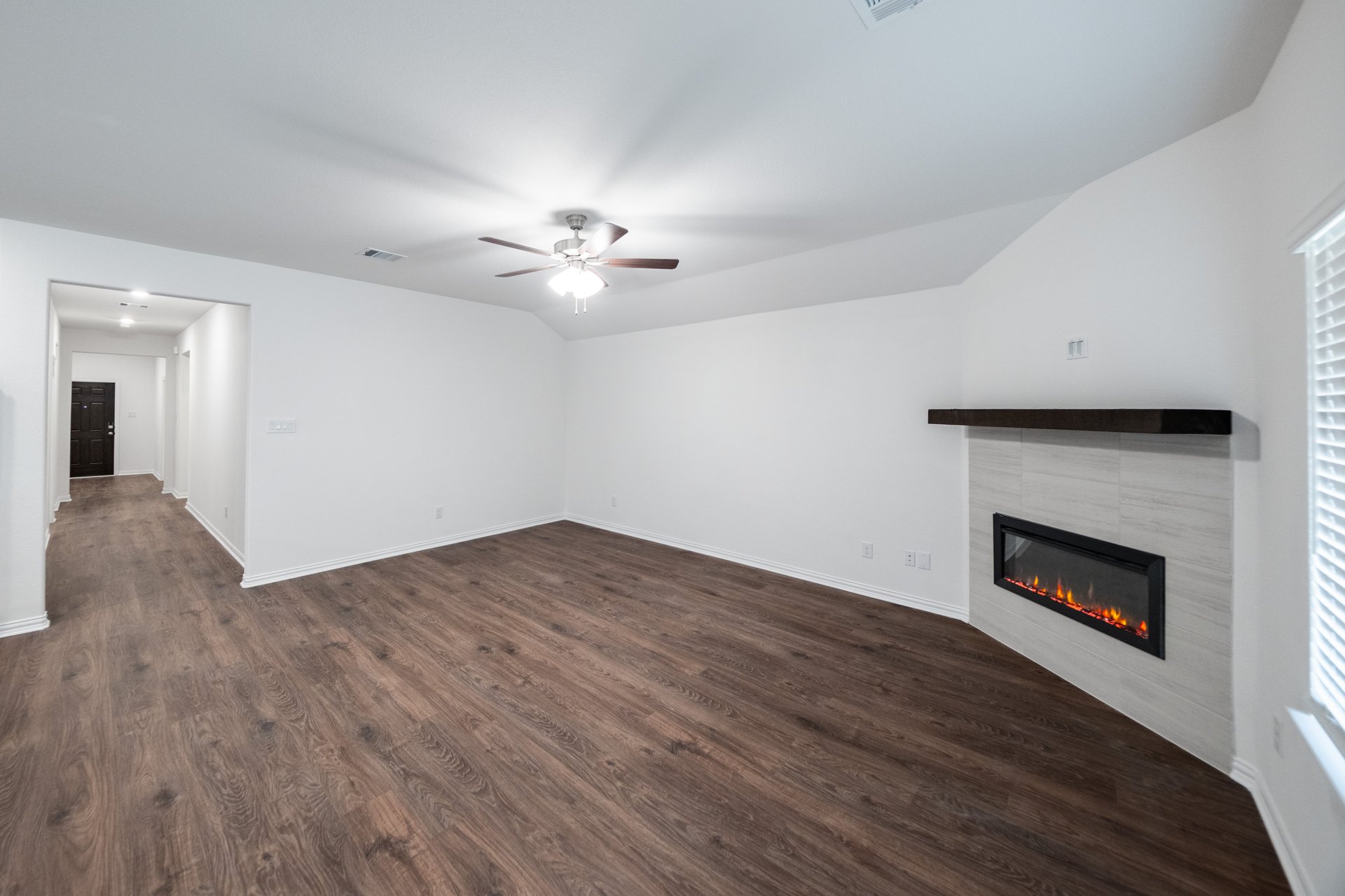 open great room with wood floors and fireplace