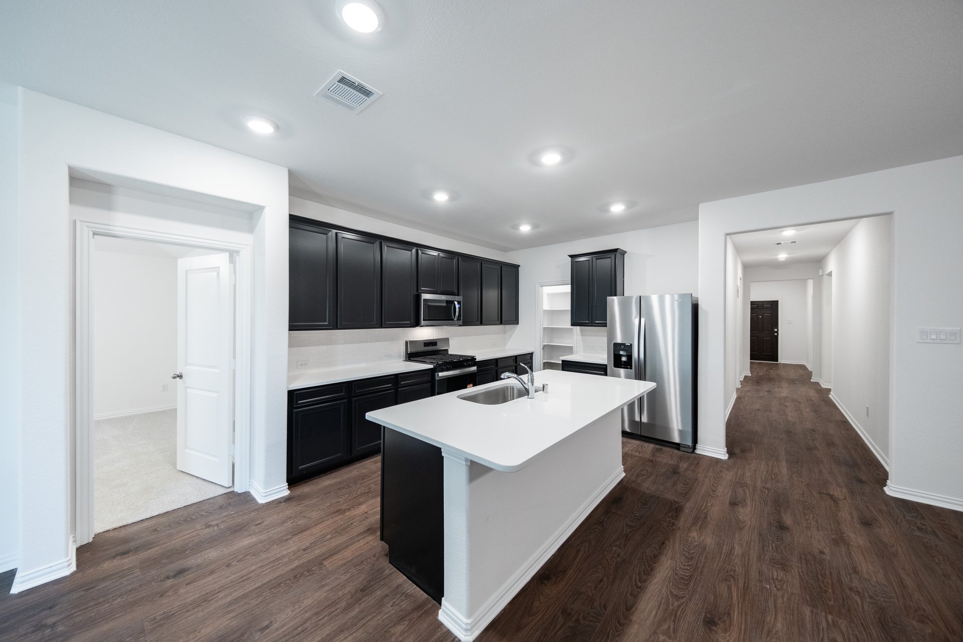 open kitchen with wood floors and island