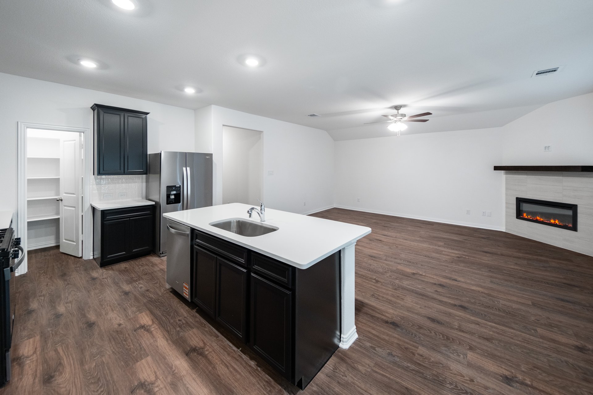 open kitchen with wood floors and island