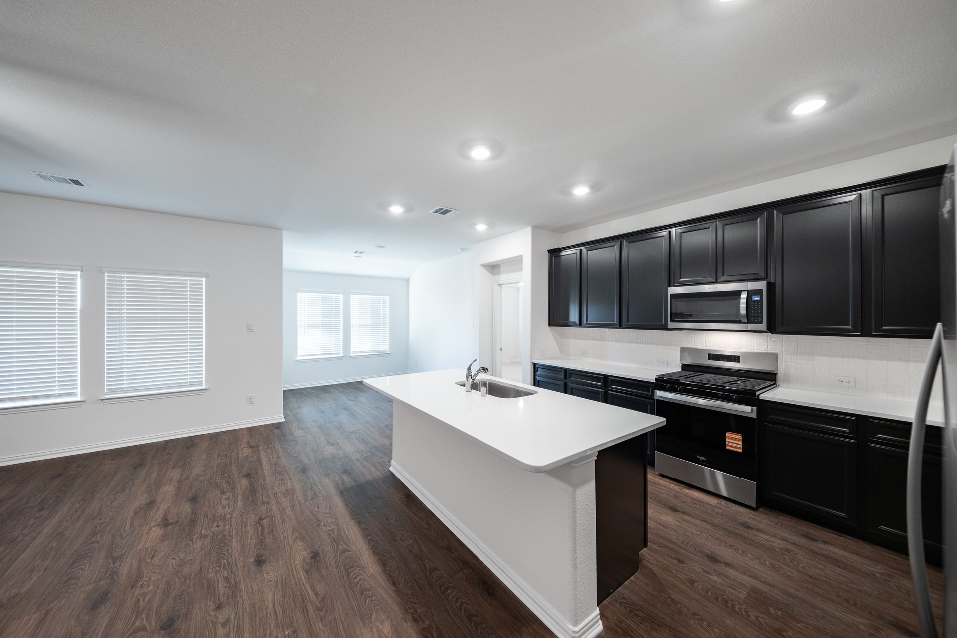 open kitchen with wood floors and island