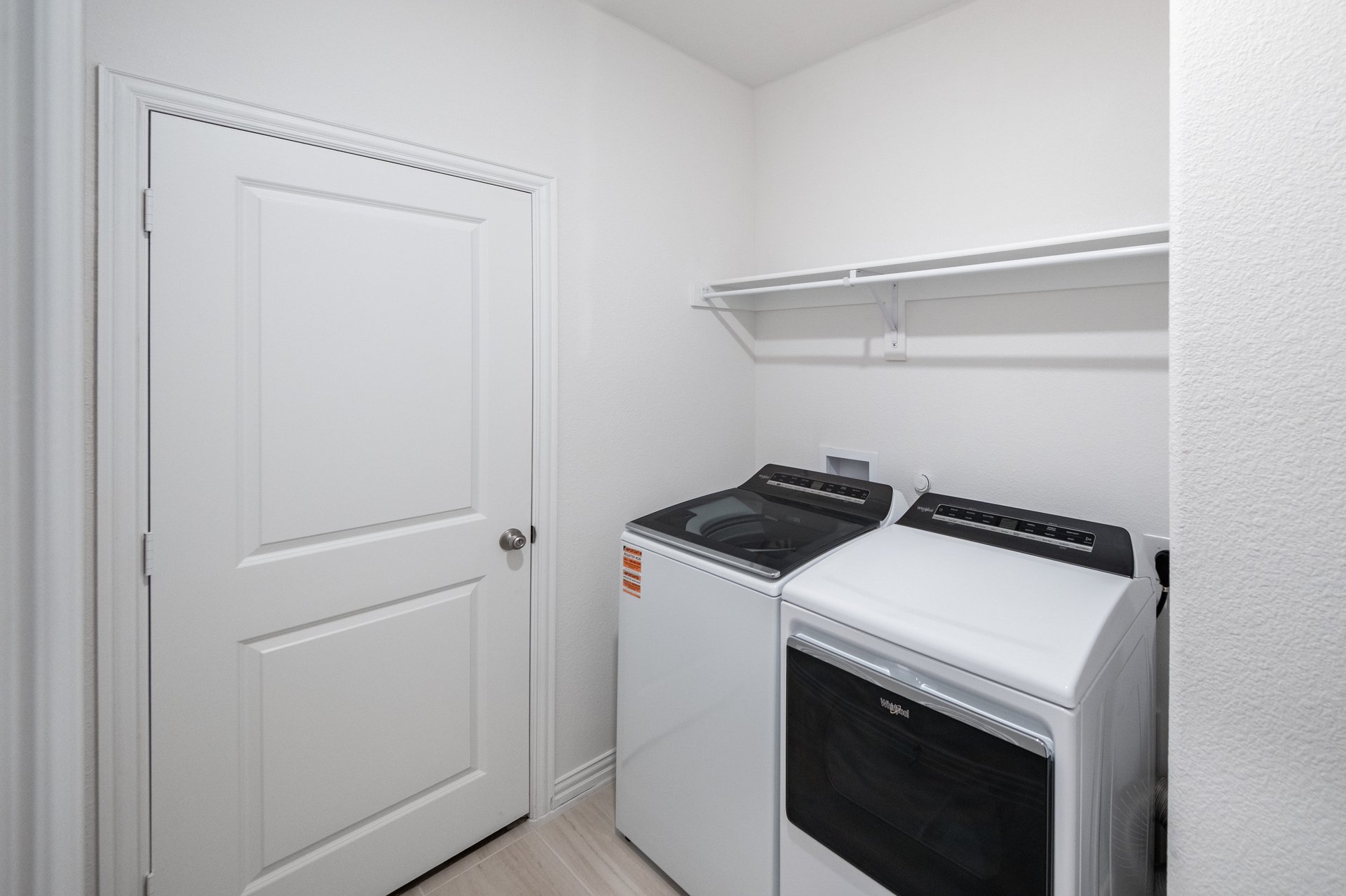 laundry room with tile floors, washer, and dryer