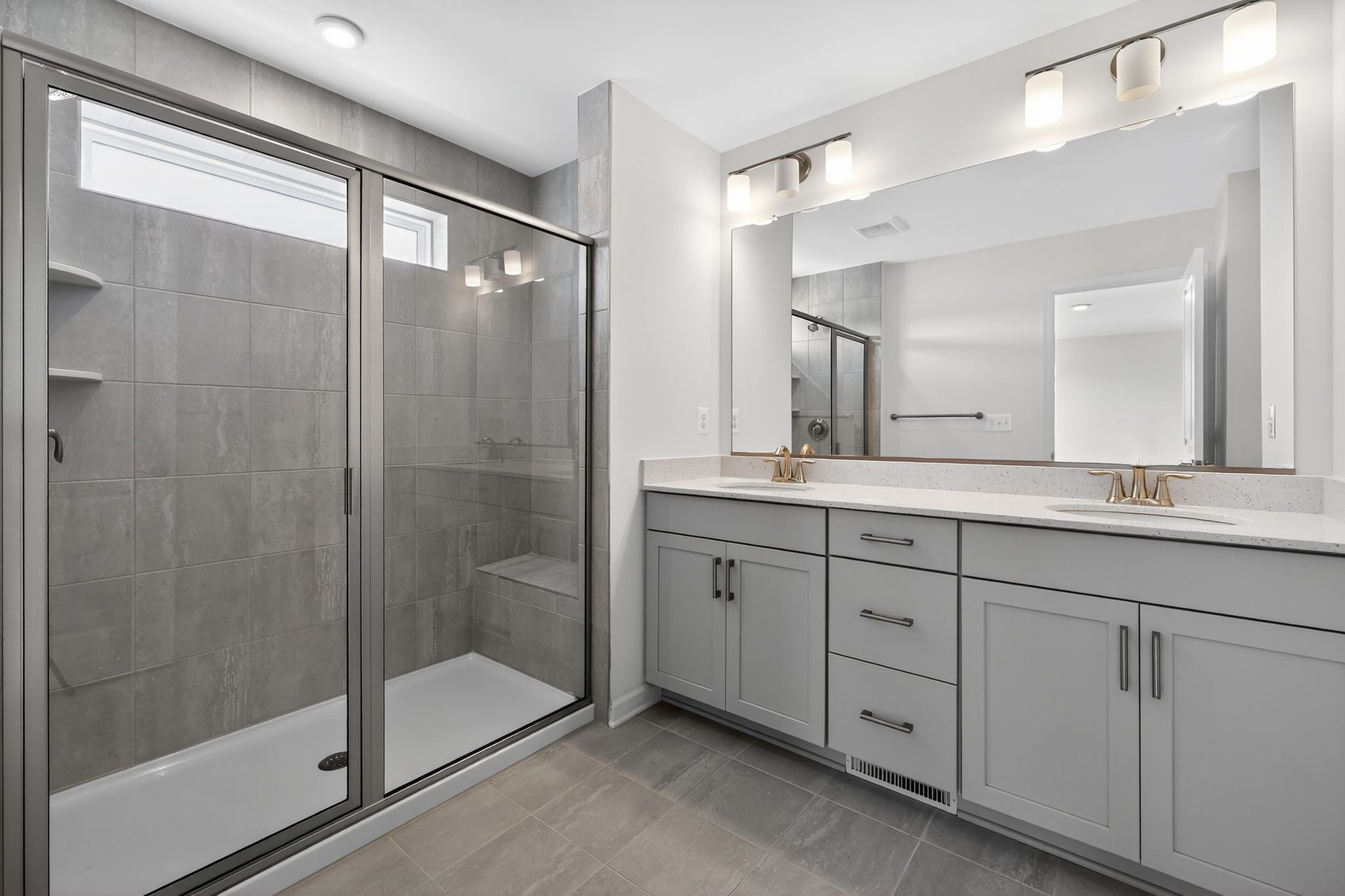 primary bath with an oversized shower and comfort heigh vanities
