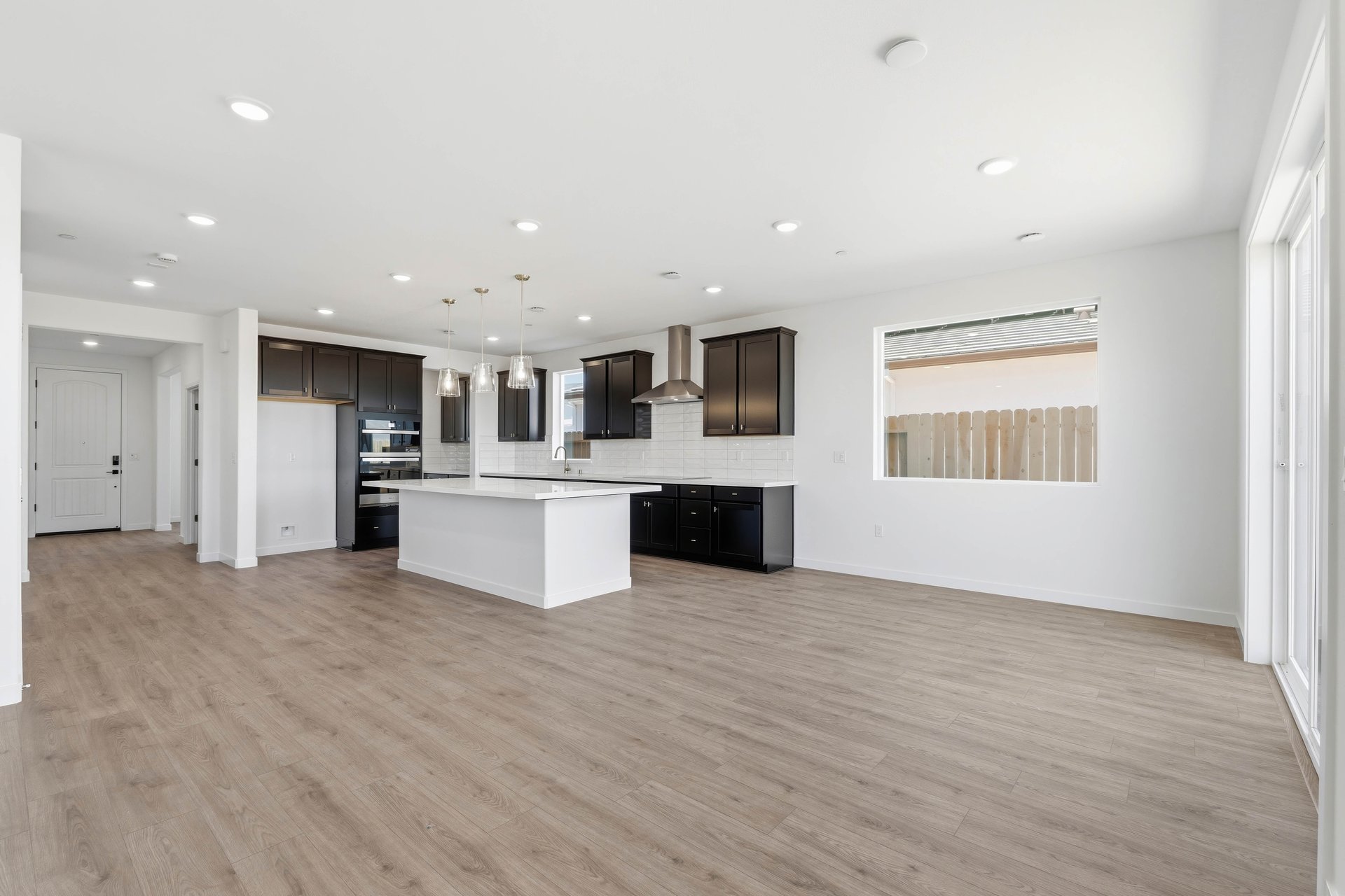 breakfast area with wood floors, white walls, and large window