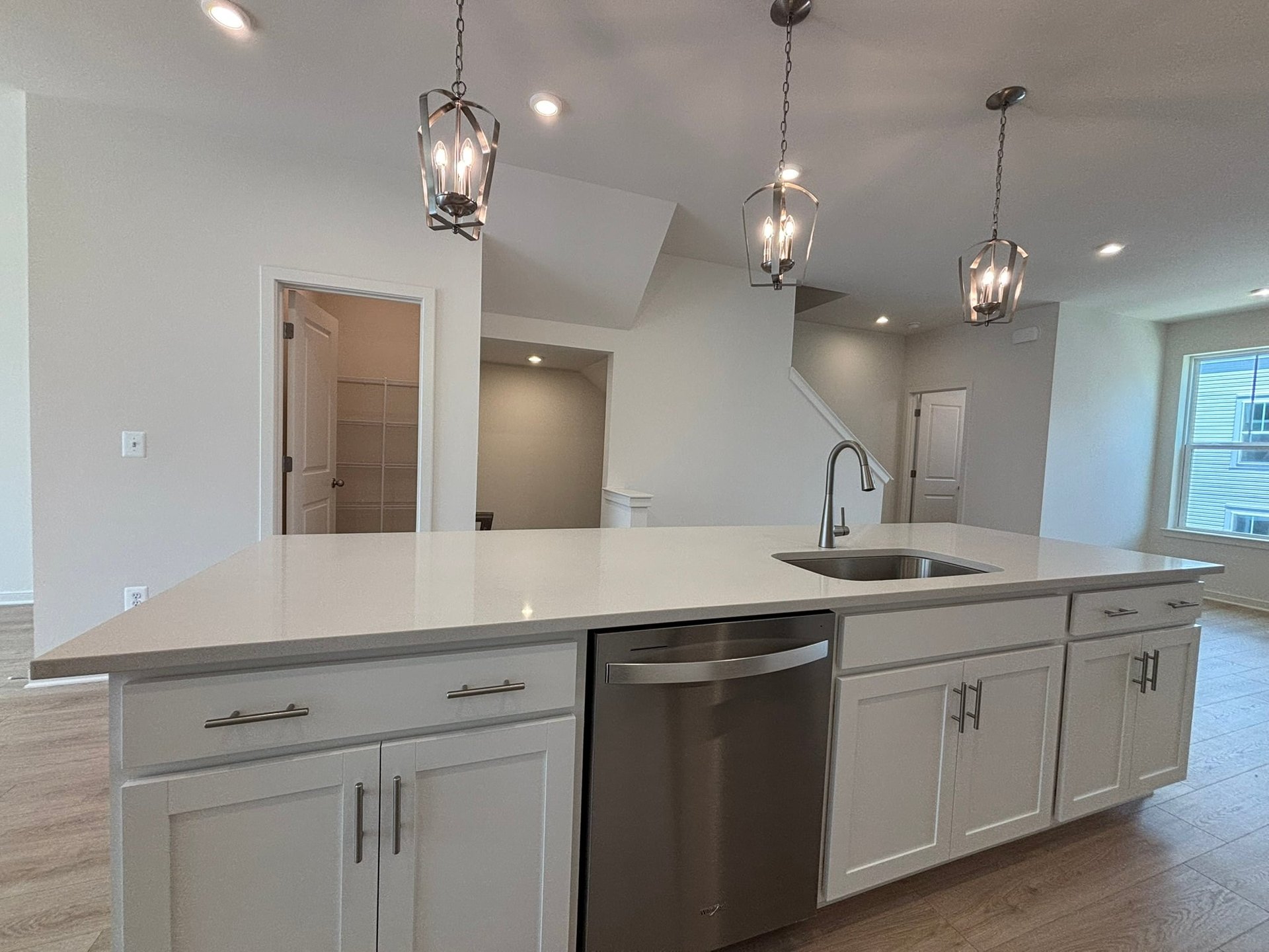 kitchen with an island with a sink and dishwasher