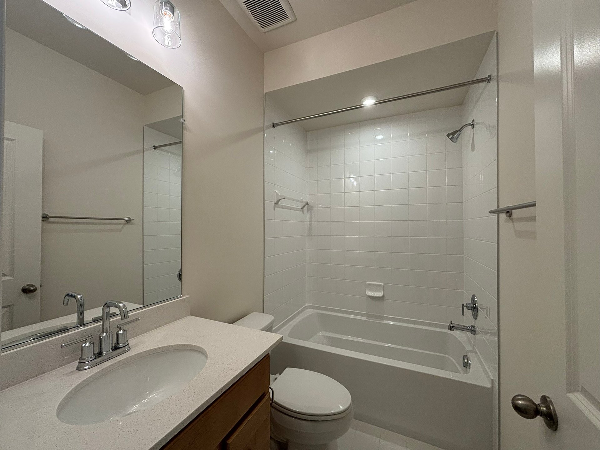 secondary bathroom with a shower and tub combo