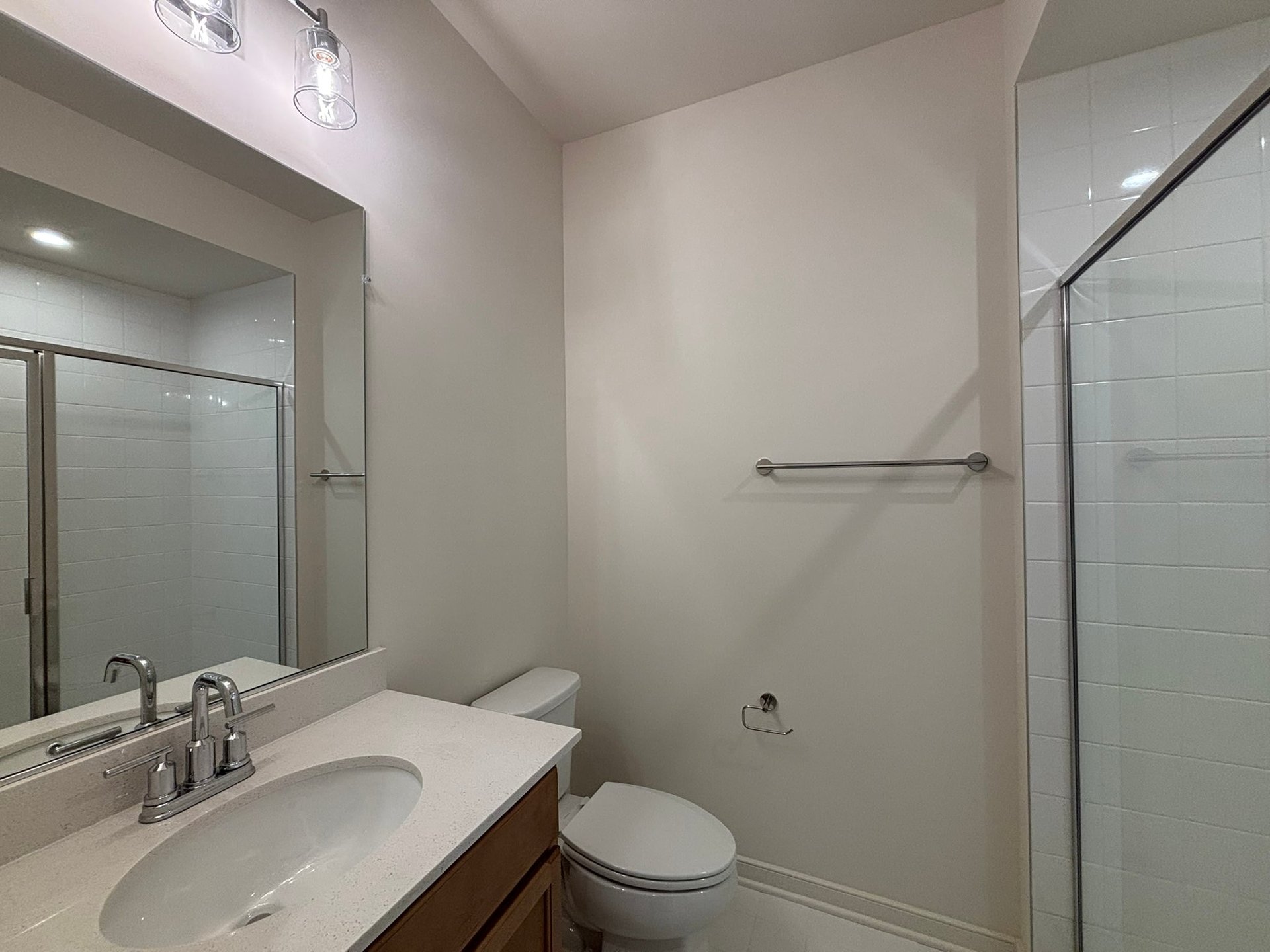 secondary bathroom with a walk-in shower