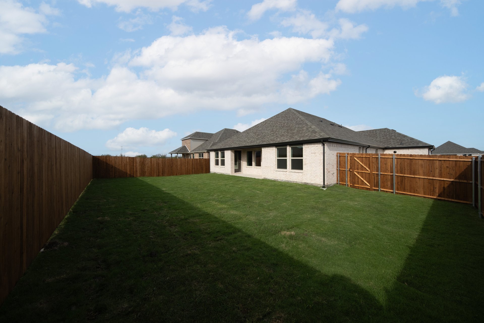 backyard with grass and covered patio