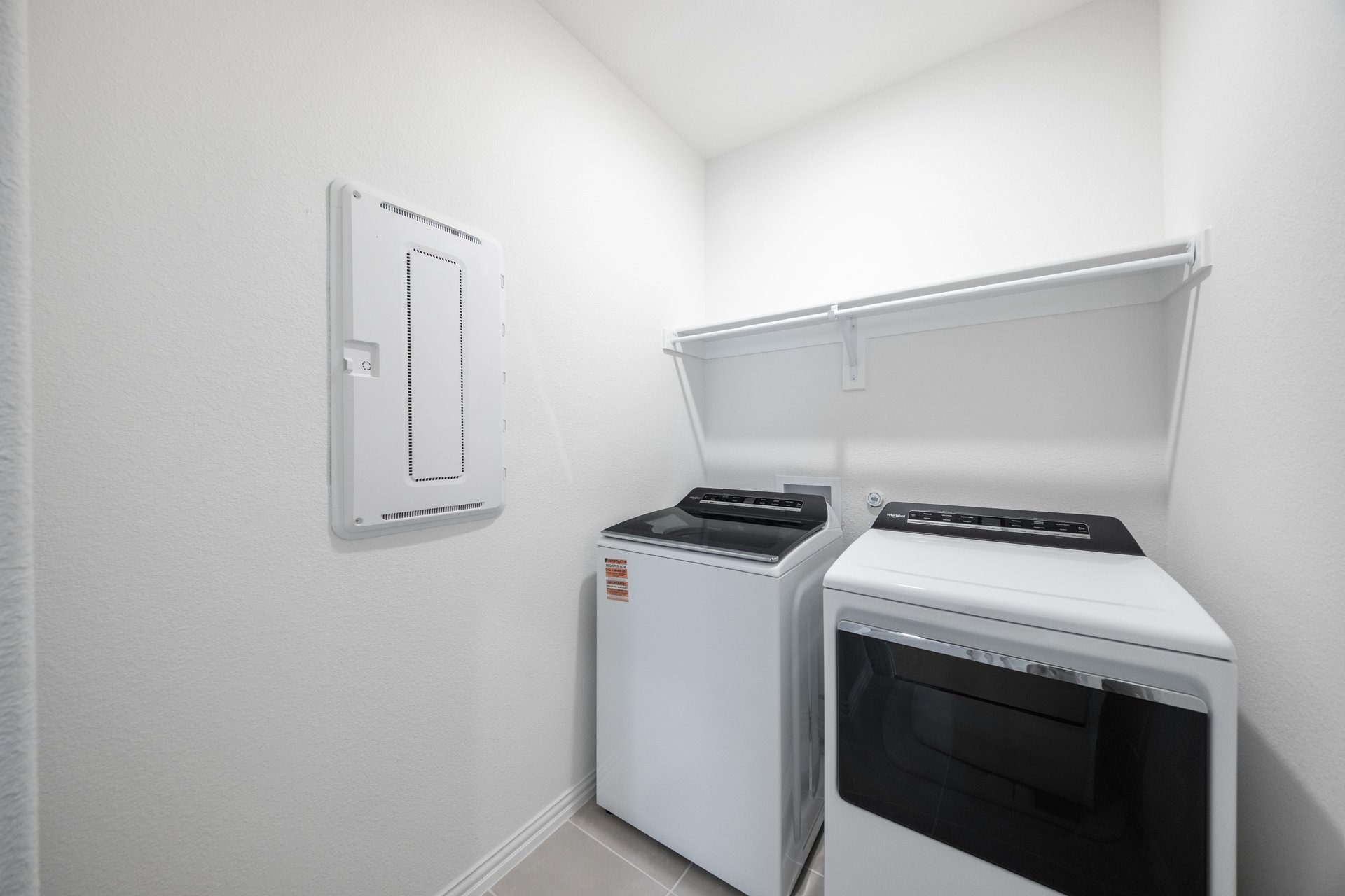 laundry room with tile floors, washer, and dryer