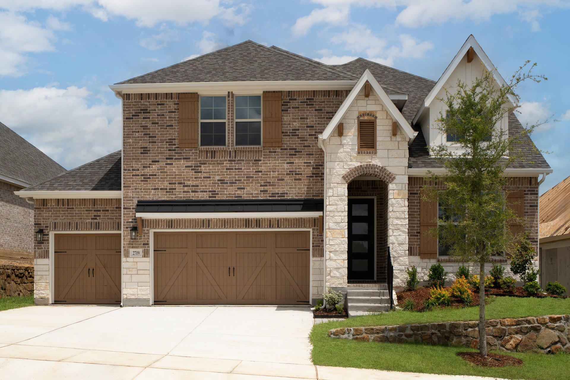 two-story home with brick and stone exterior