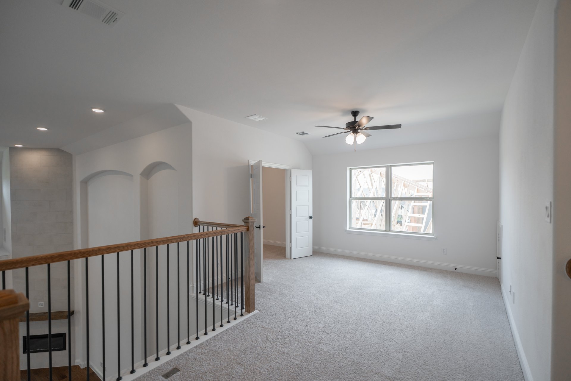 open gameroom with carpet and ceiling fan
