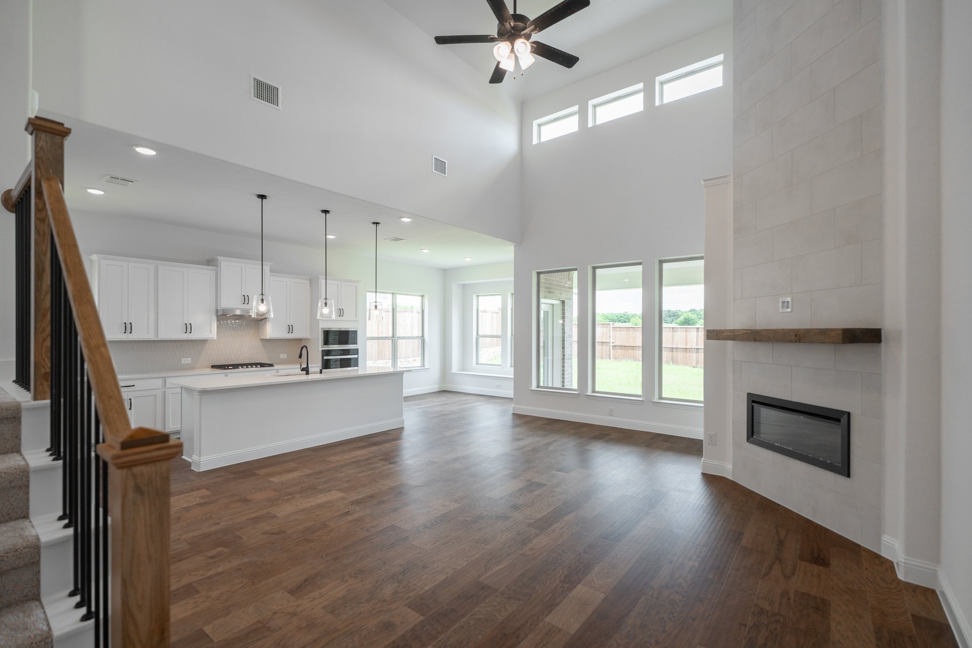 open great room with wood floors and fireplace