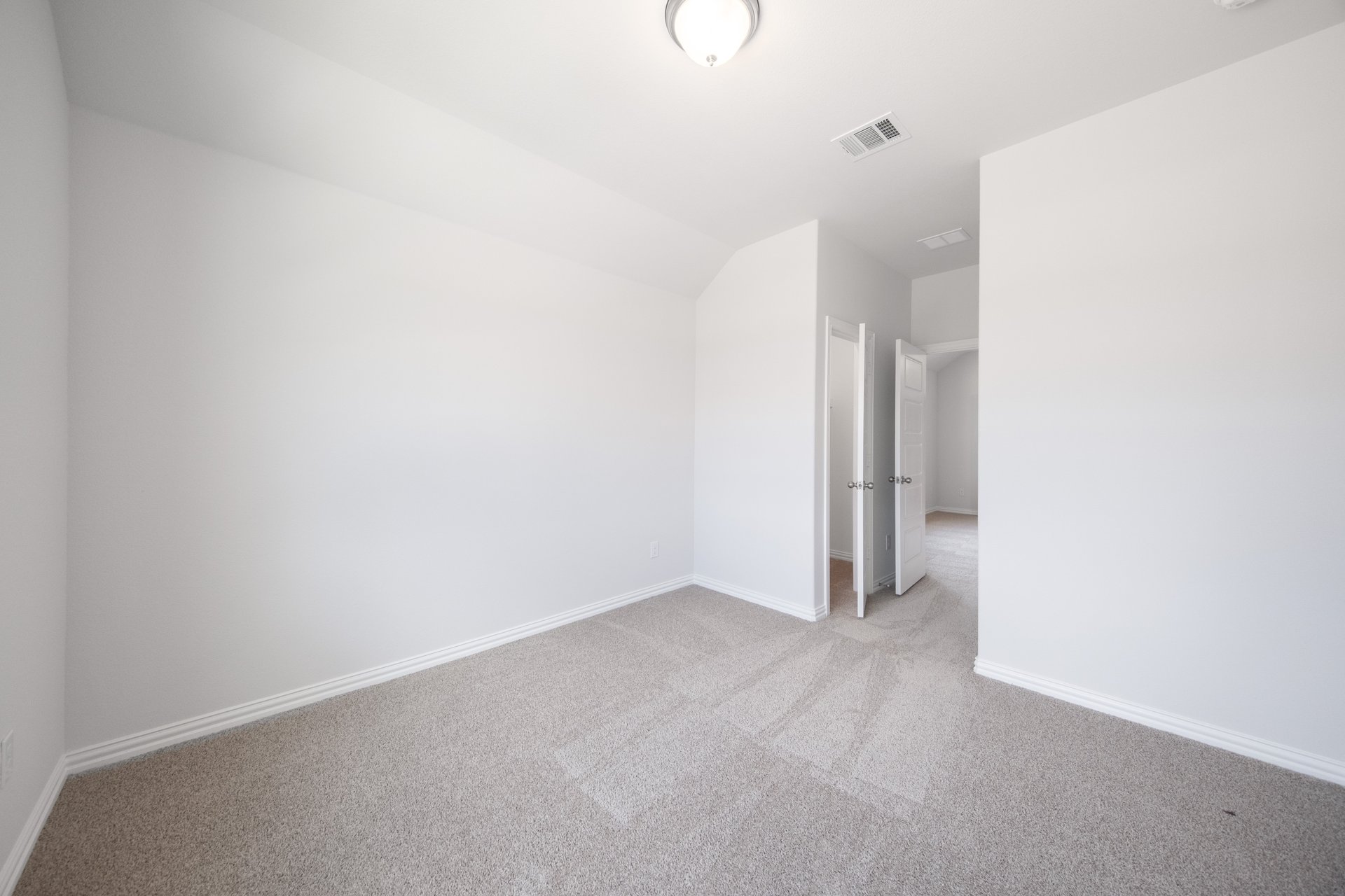 guest bedroom with carpet and window