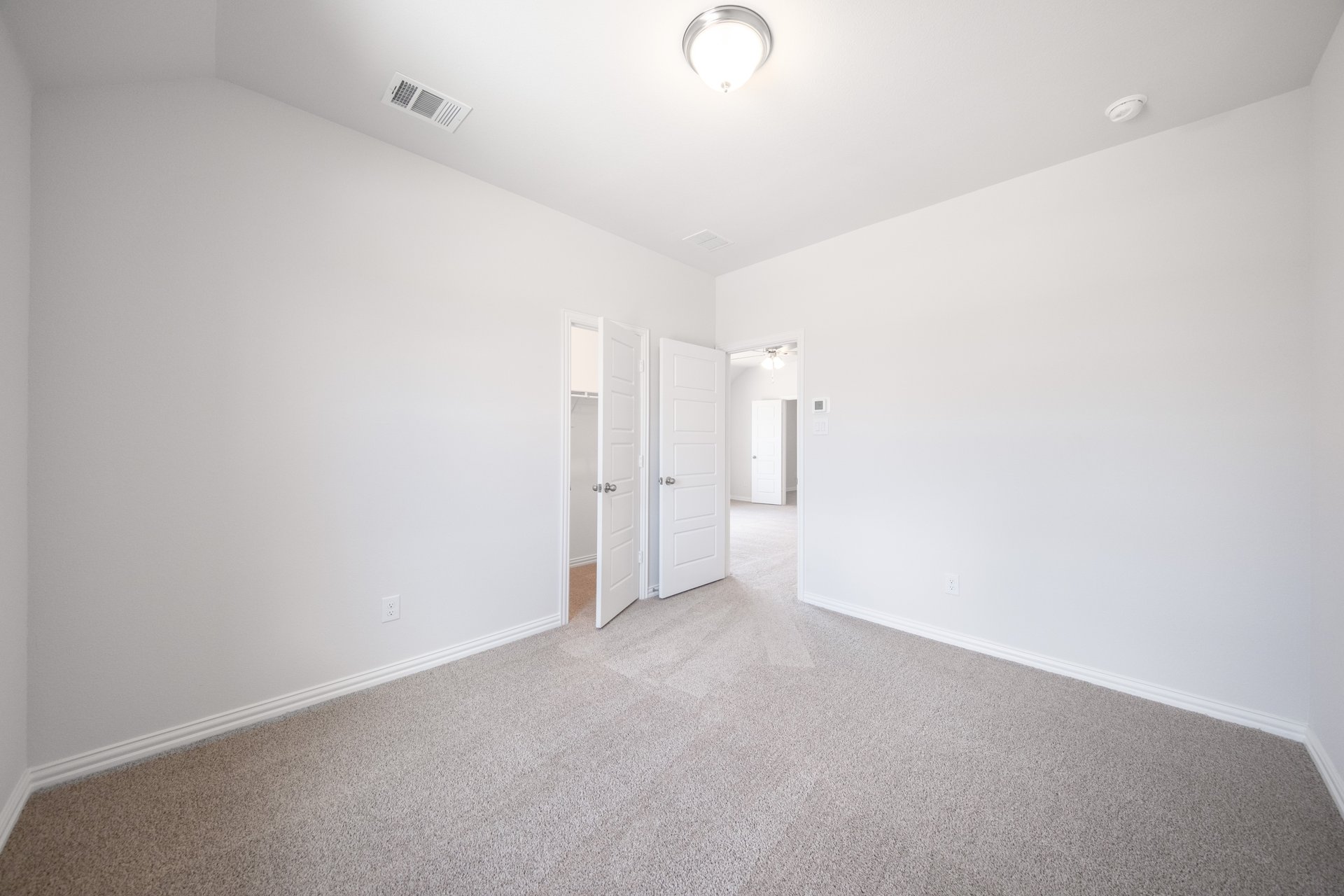 guest bedroom with carpet and window