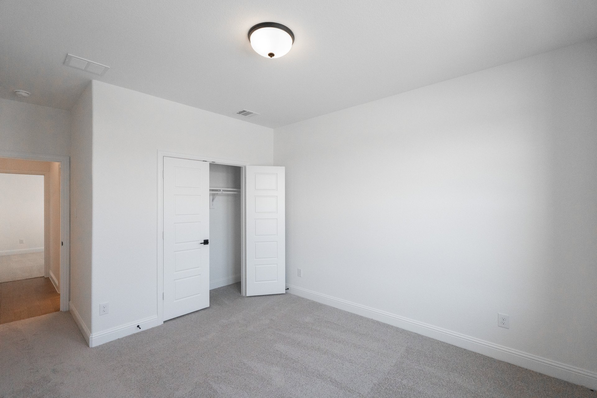 guest bedroom with carpet and window