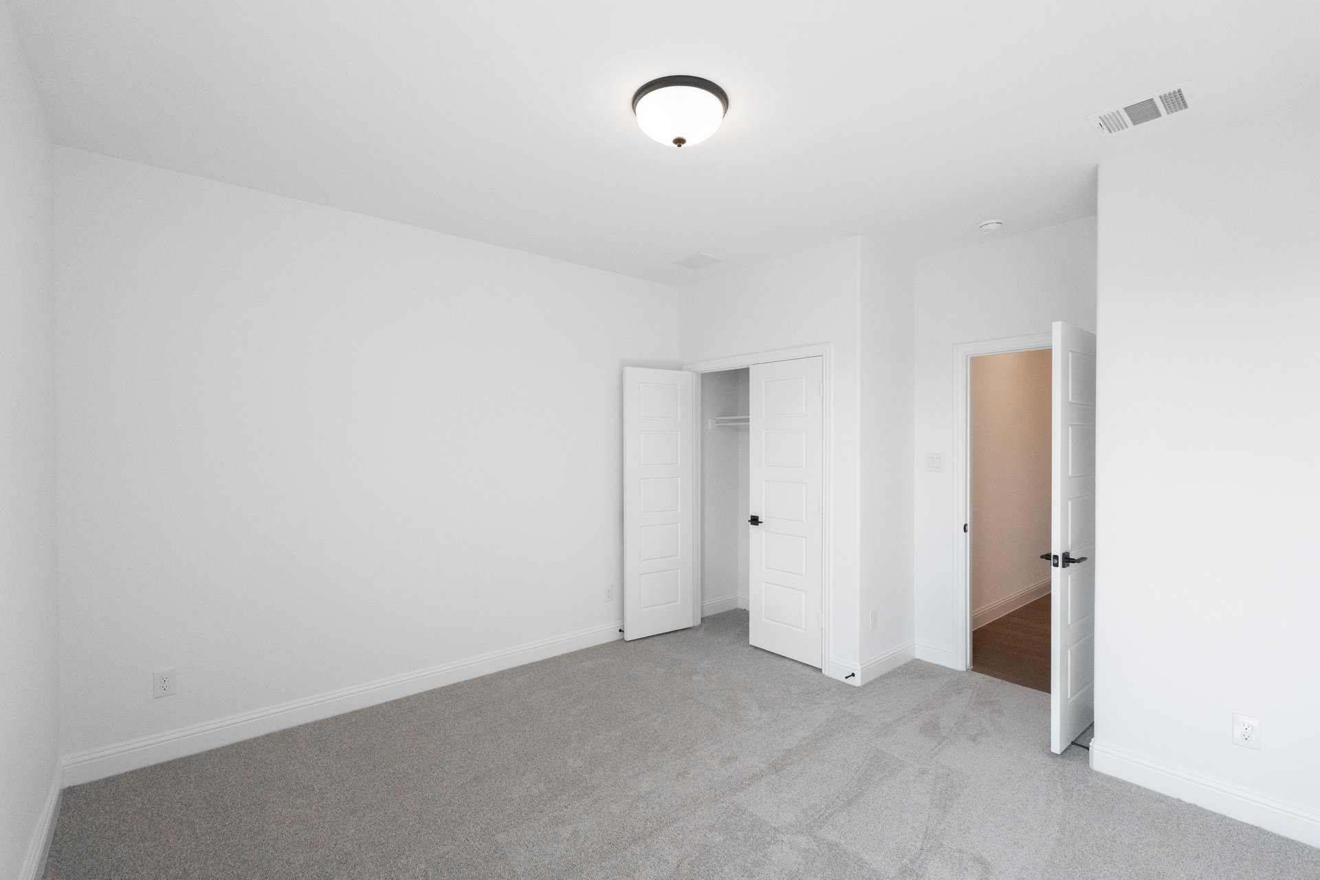 guest bedroom with carpet and window