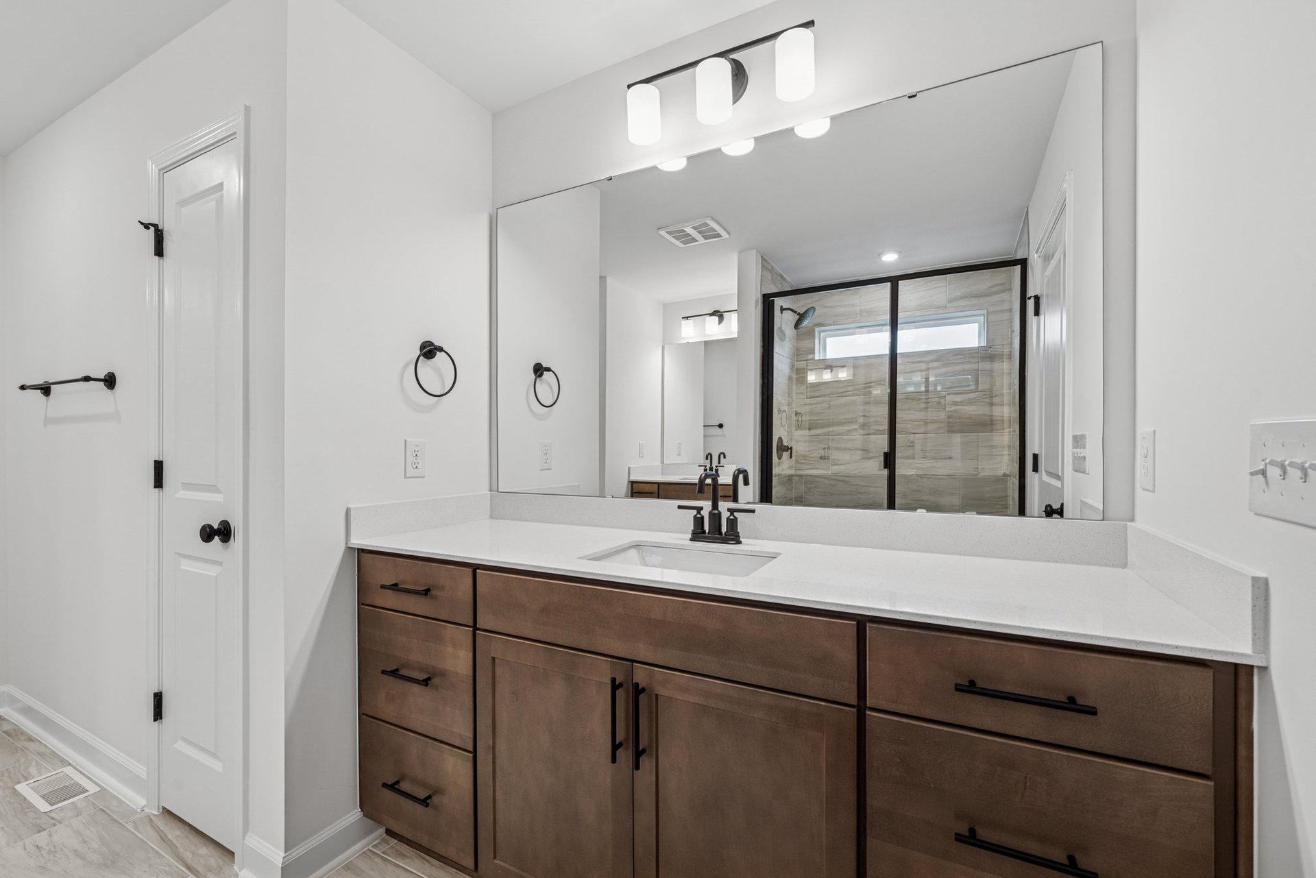 primary bathroom with white countertops