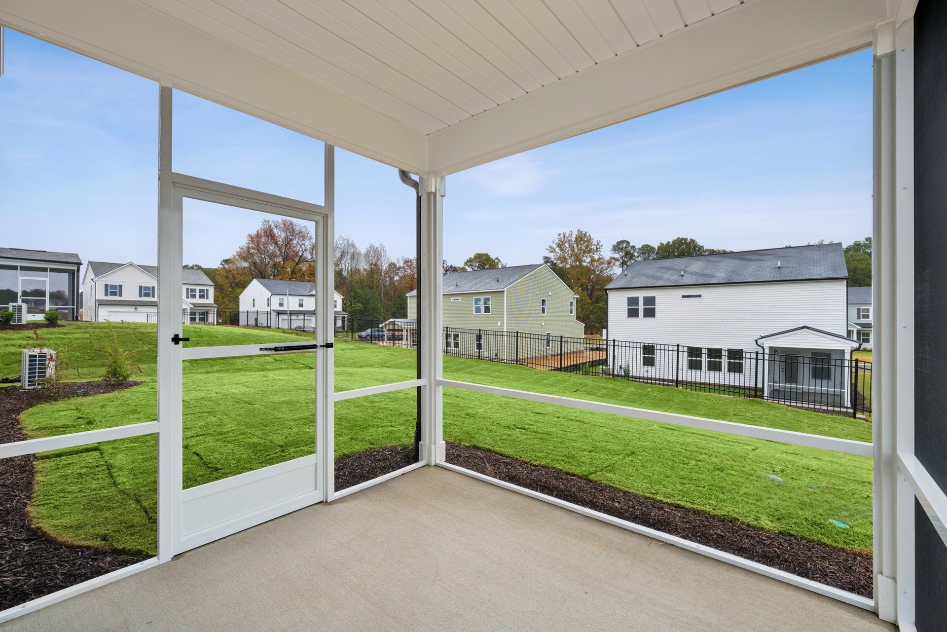 screened porch with view of backyard