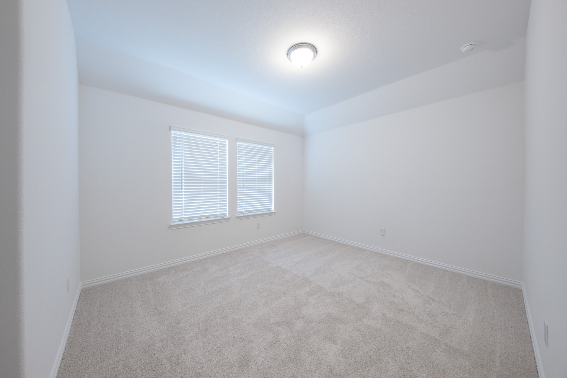 guest bedroom with carpet and window
