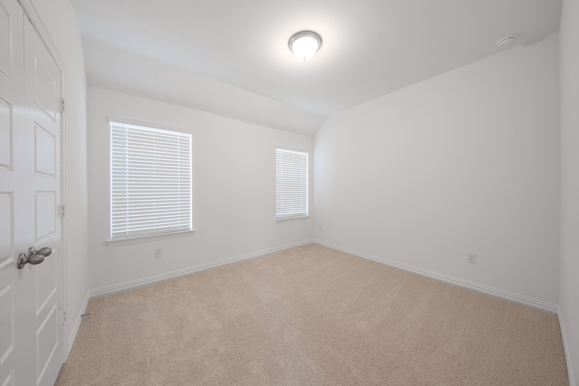 guest bedroom with carpet and window
