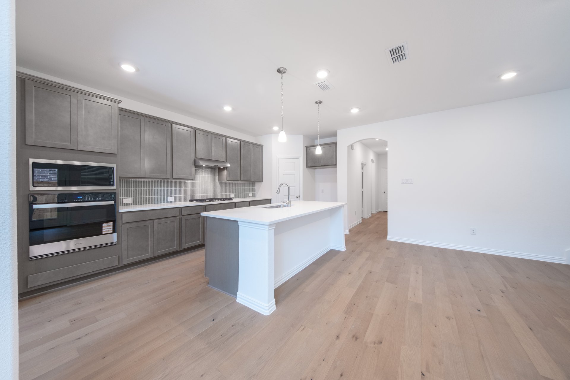 open kitchen with gray cabinets and white countertop