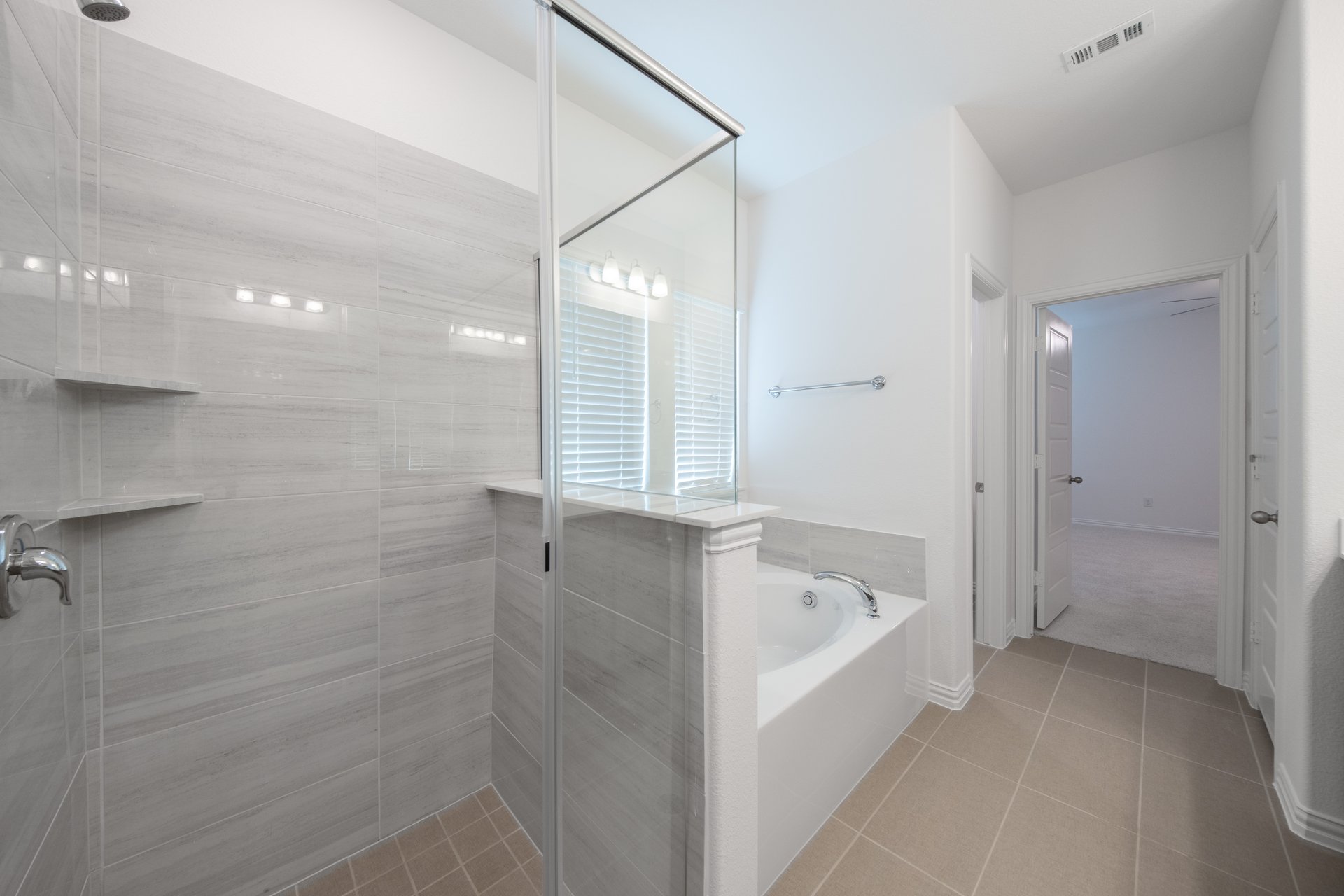 primary bathroom with separate walk-in shower and soaking tub