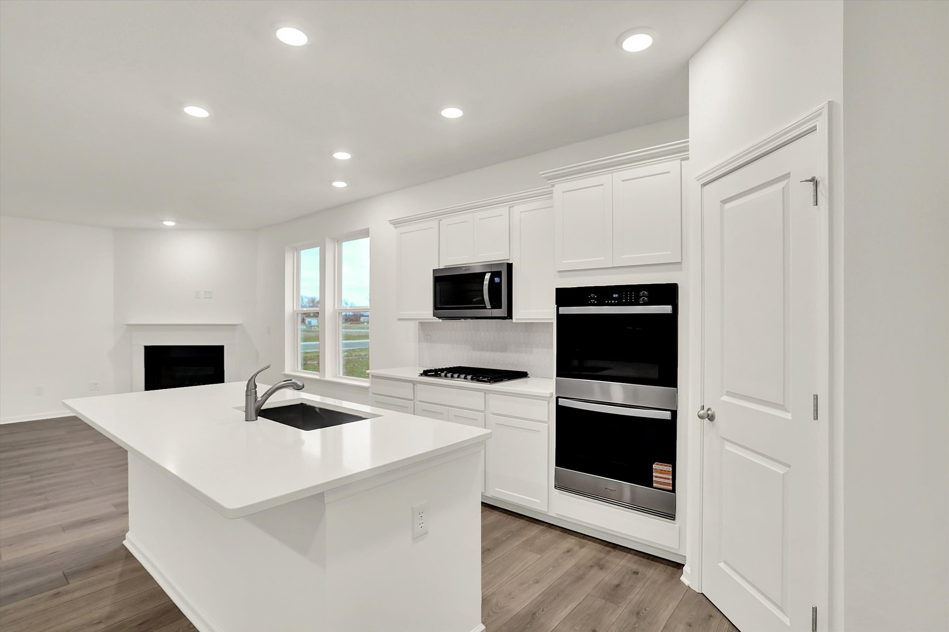 kitchen with white countertops and a built-in sink in the island