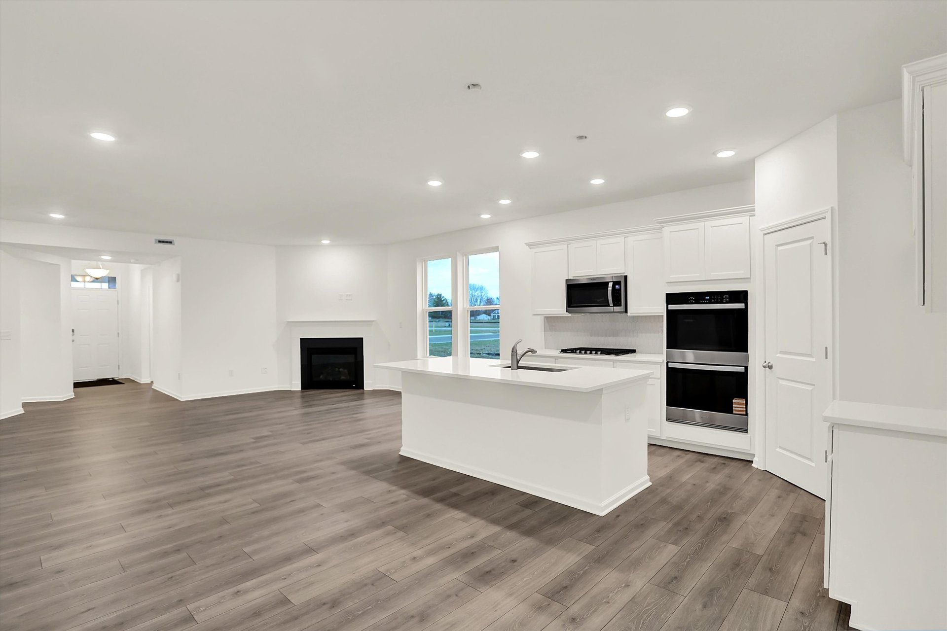 kitchen with wood plank flooring that is also open to the great room