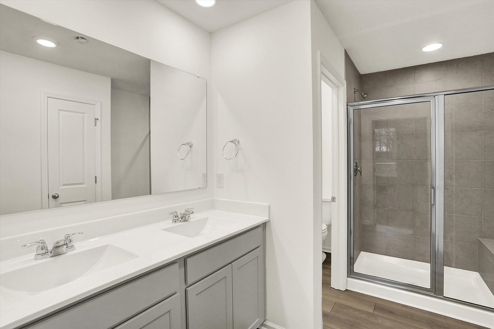 bathroom with gray cabinets and dual sink vanity