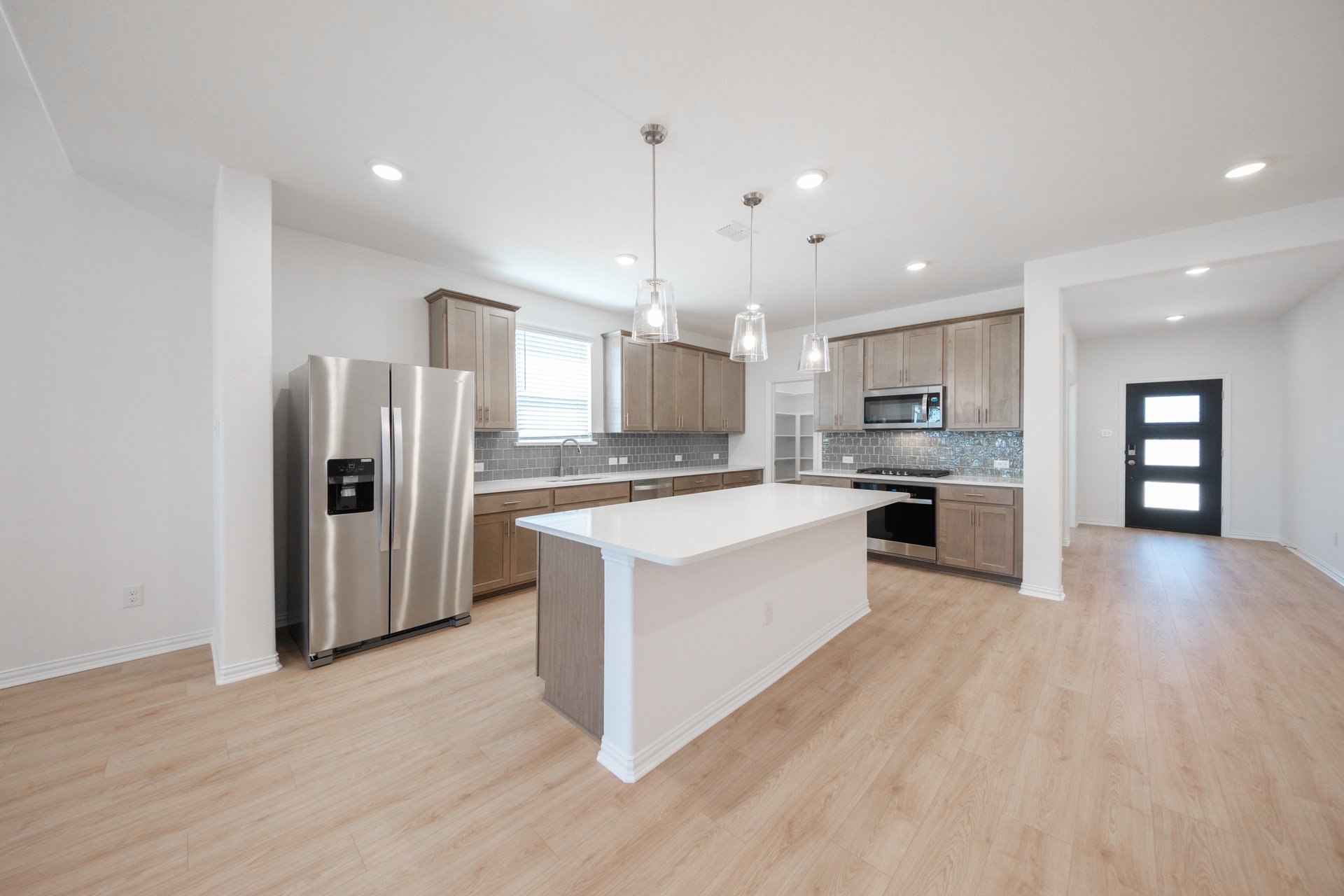 open kitchen with brown cabinets