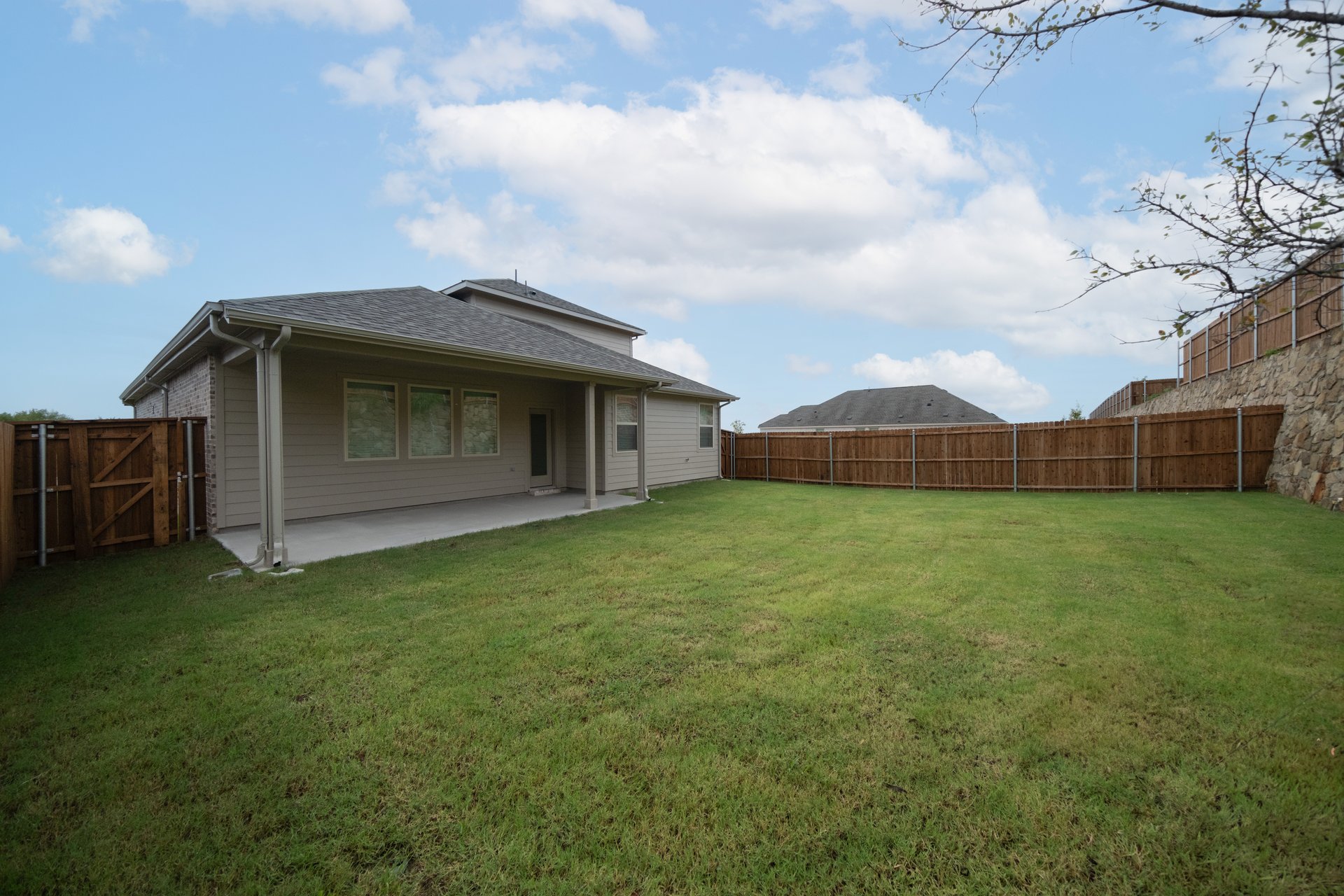 backyard of home with grass and covered patio