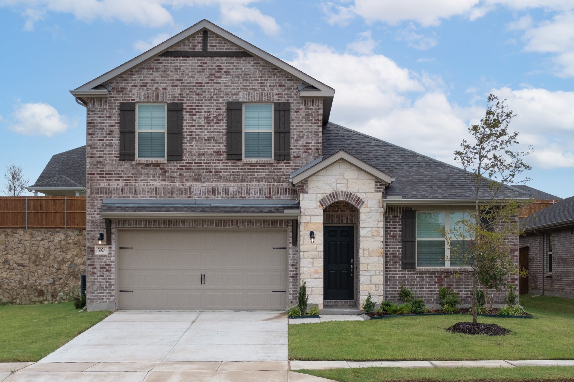 exterior of home with brown brick and white stone