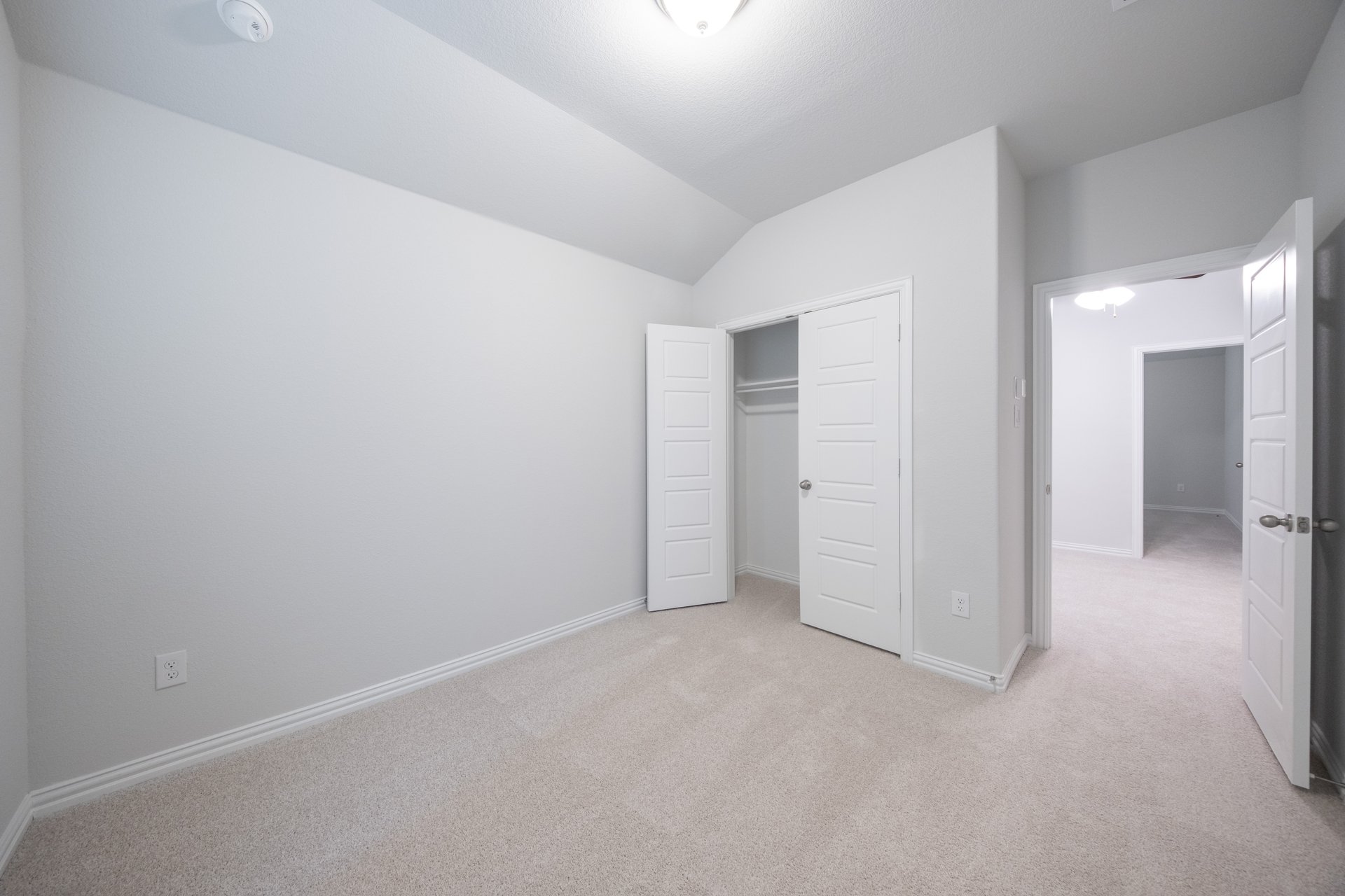 guest bedroom with carpet and walk-in closet