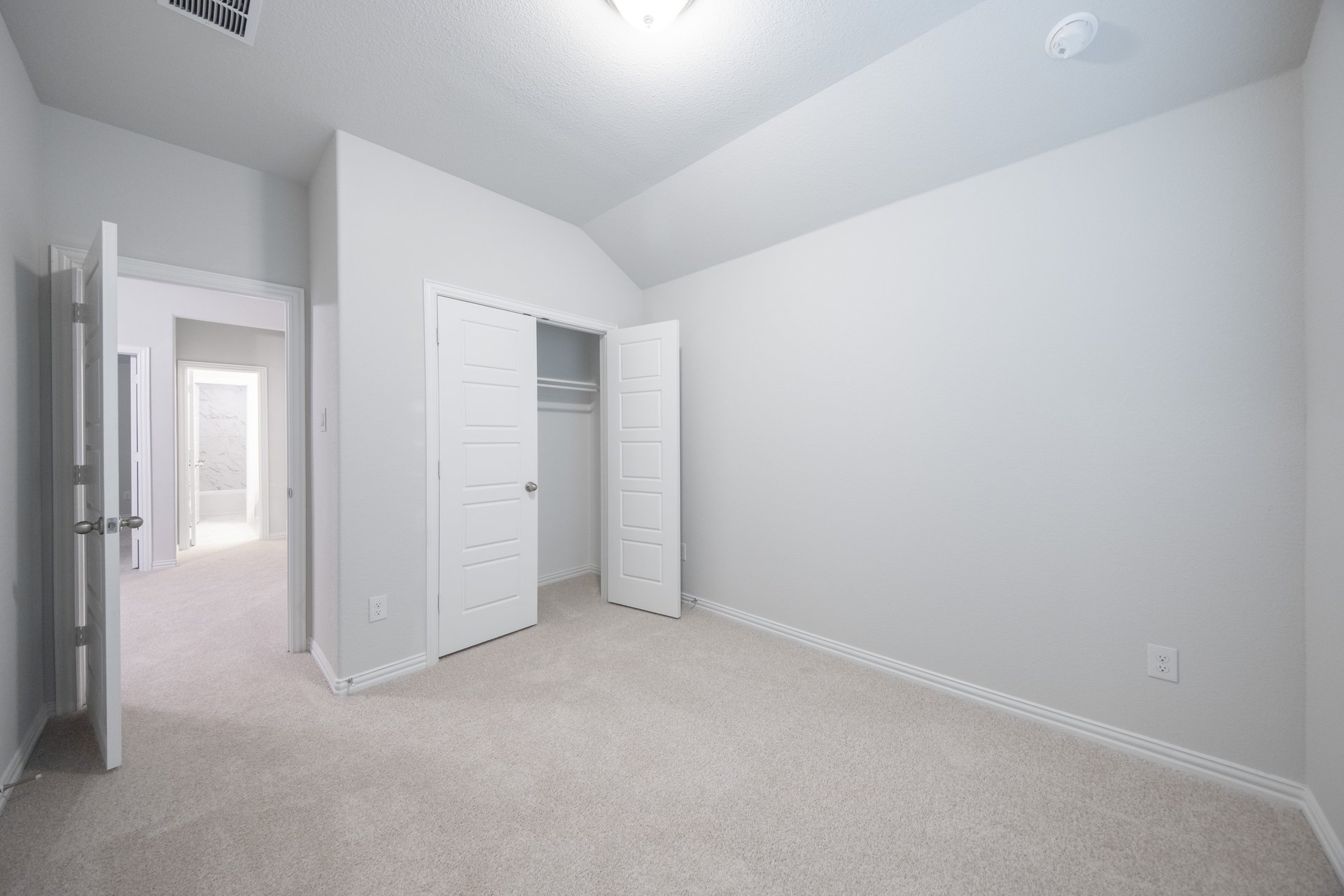 guest bedroom with walk-in closet