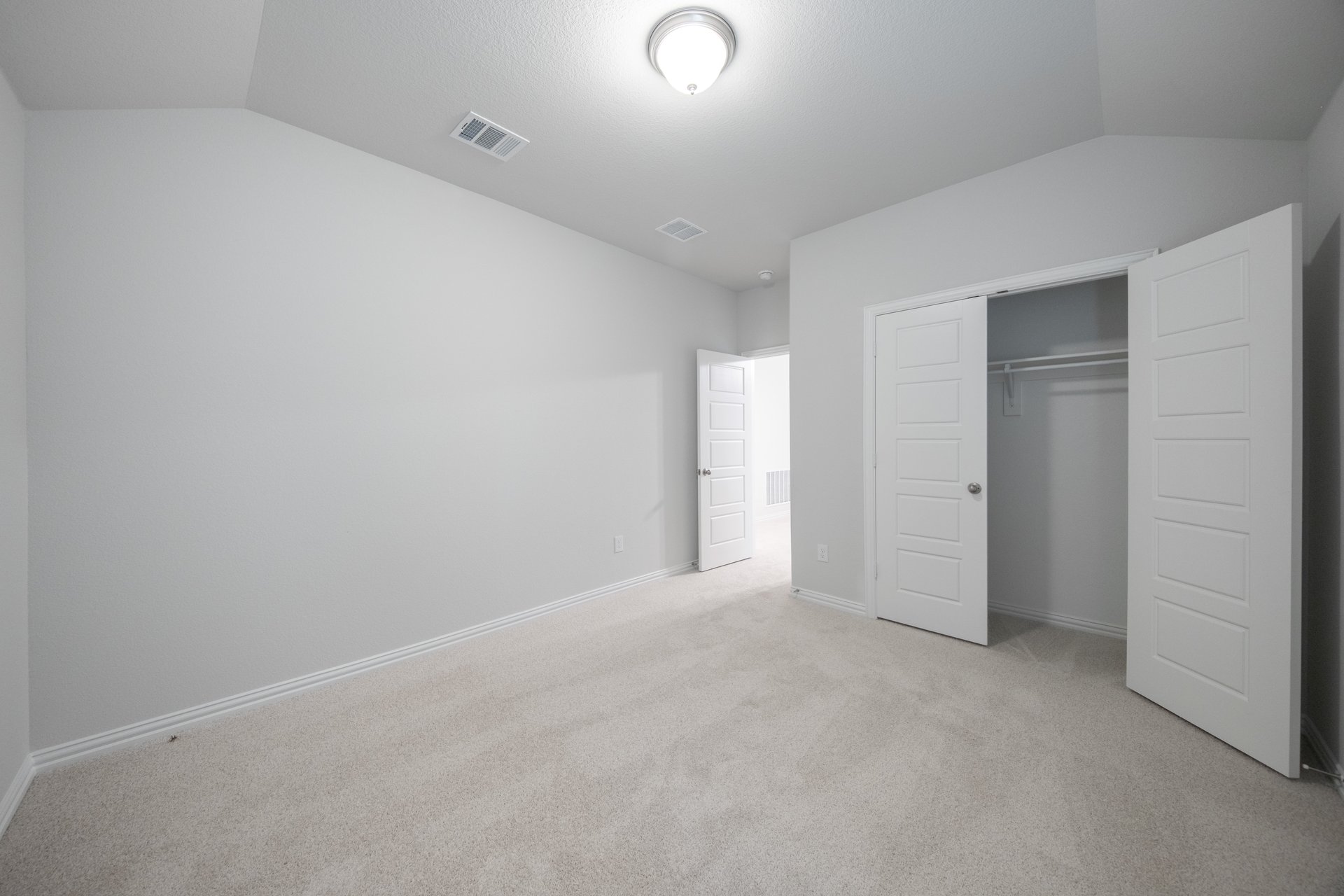 guest bedroom with walk-in closet