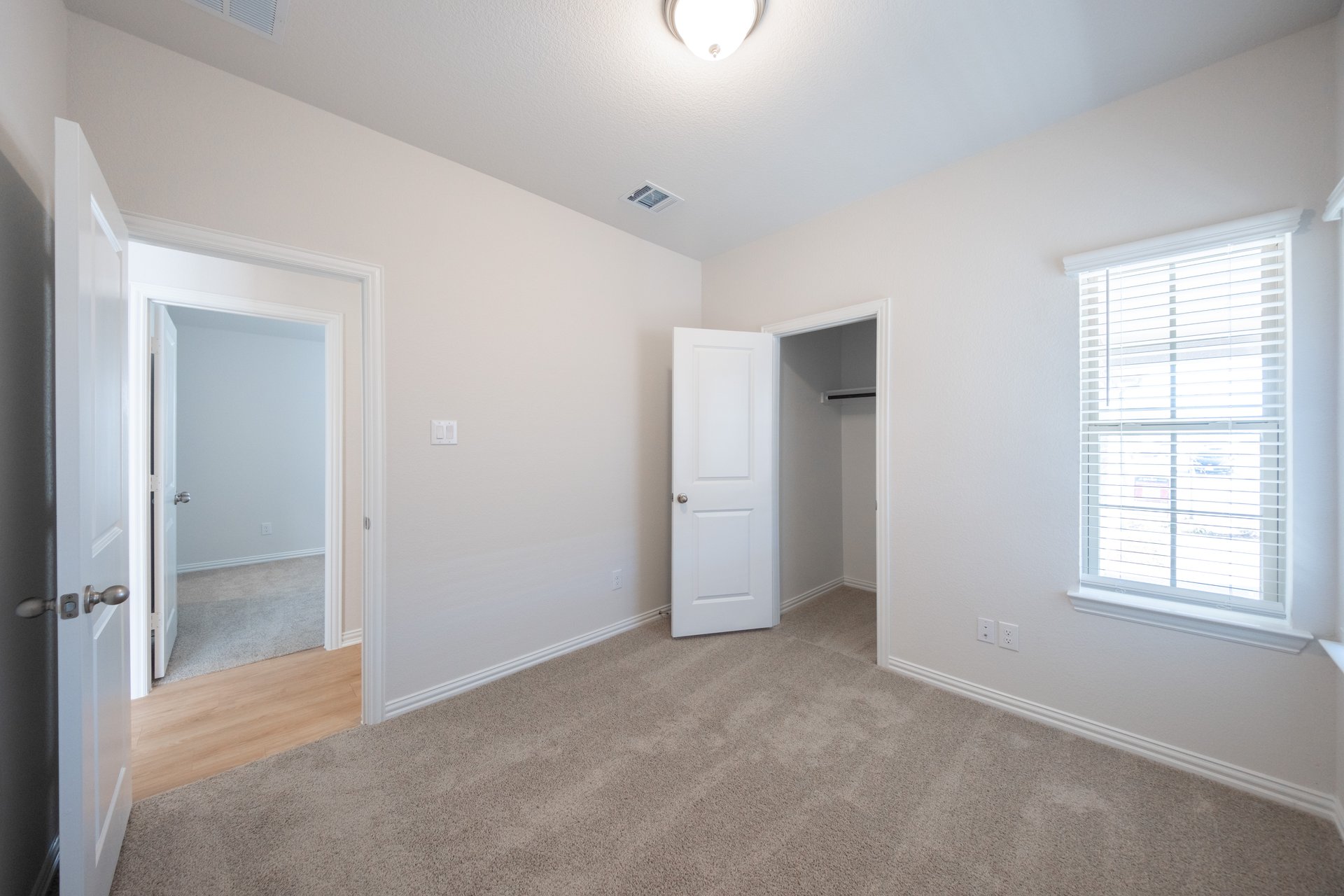 bedroom with carpet and window with blinds 