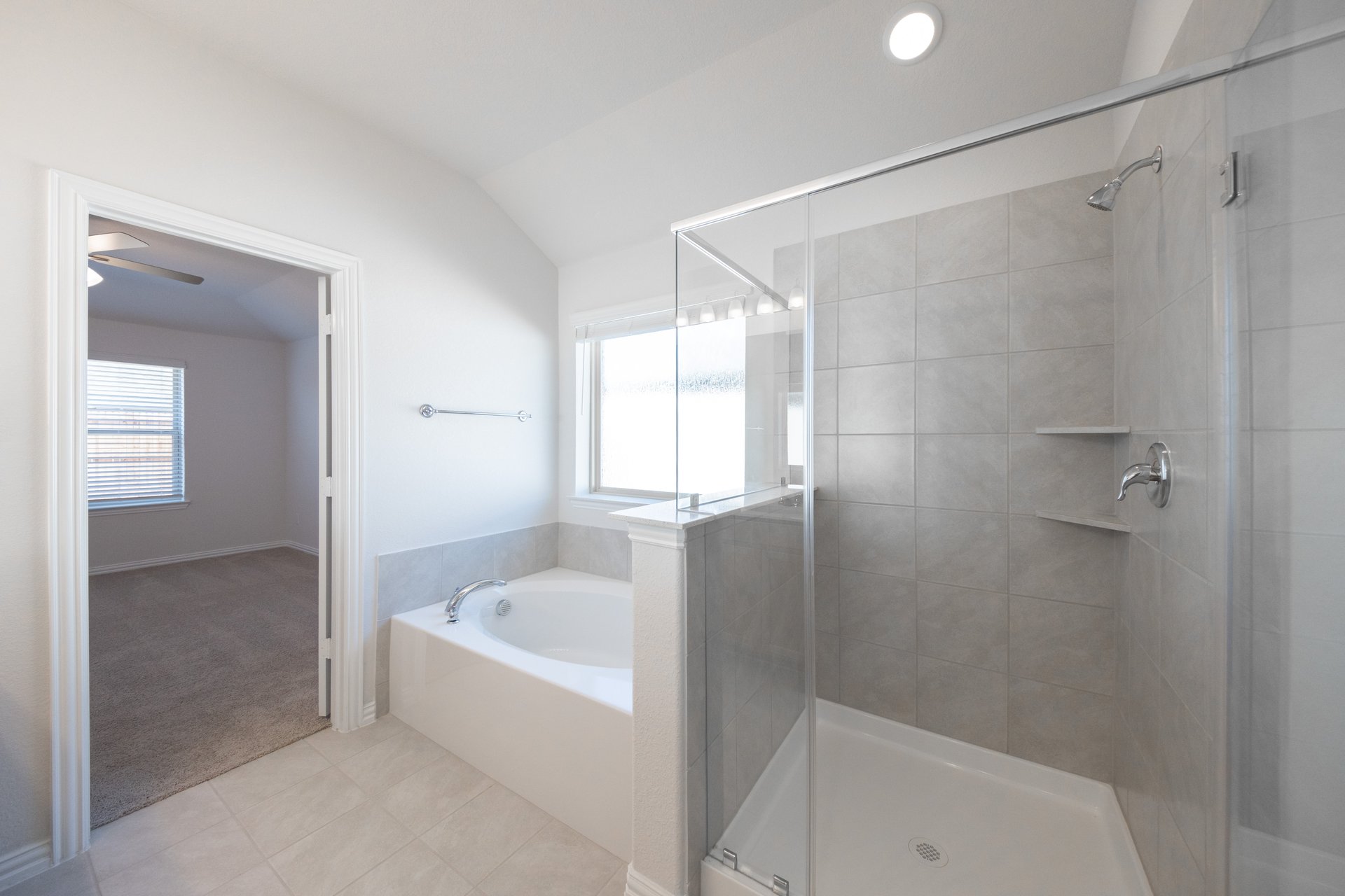 bathroom with large soaking tub and walk-in shower