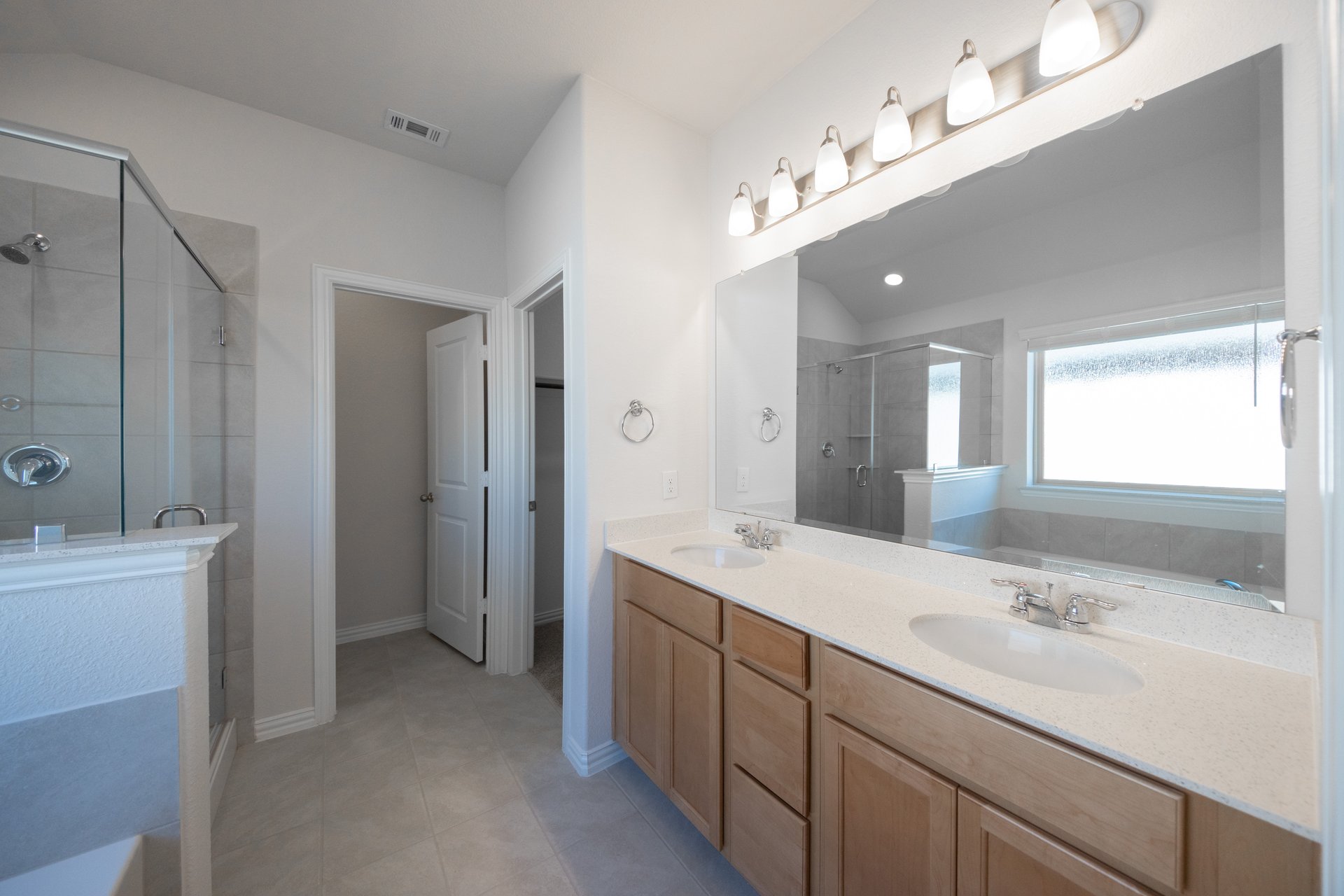 bathroom with brown cabinets and tile 