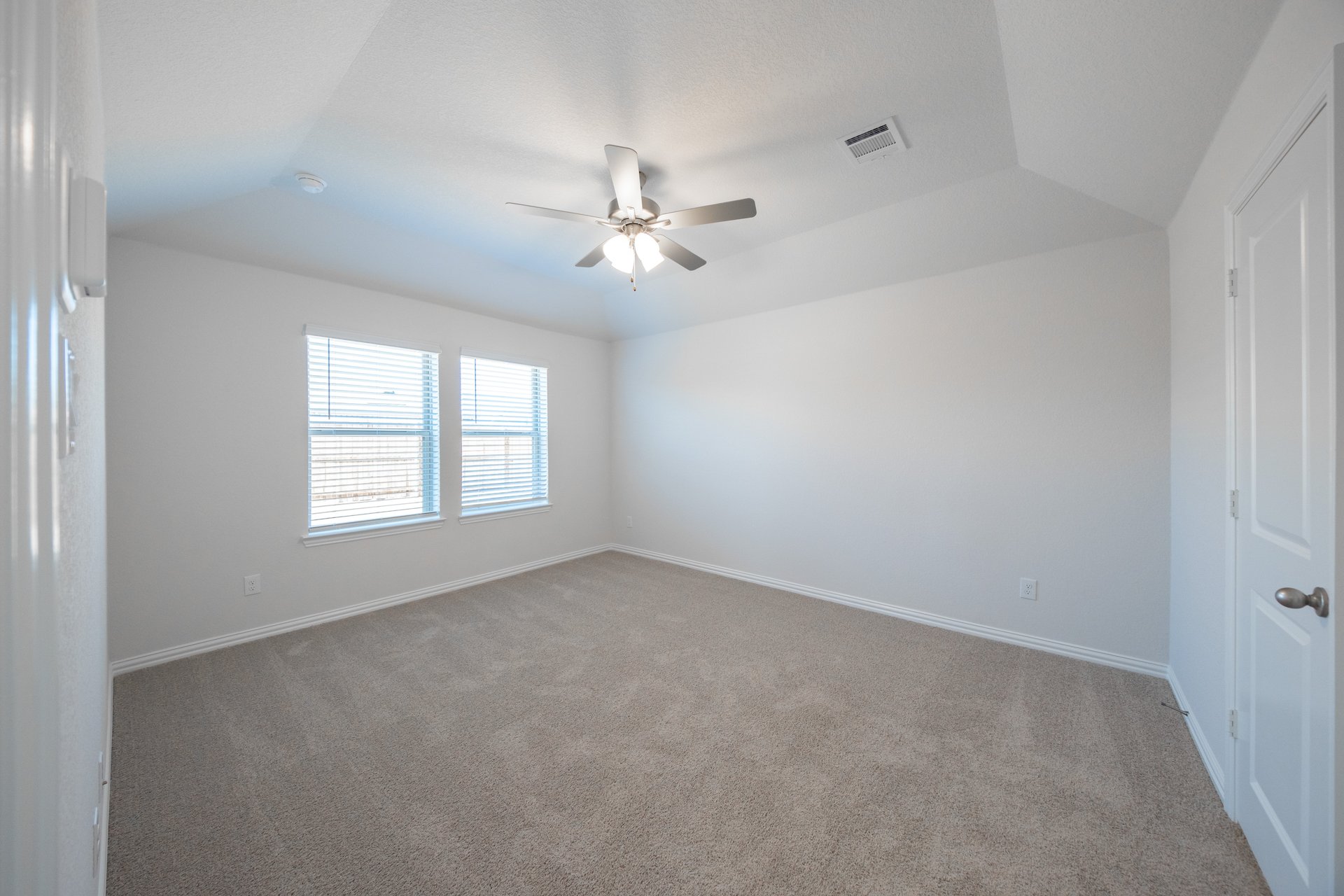 bedroom with windows with blinds and carpet 