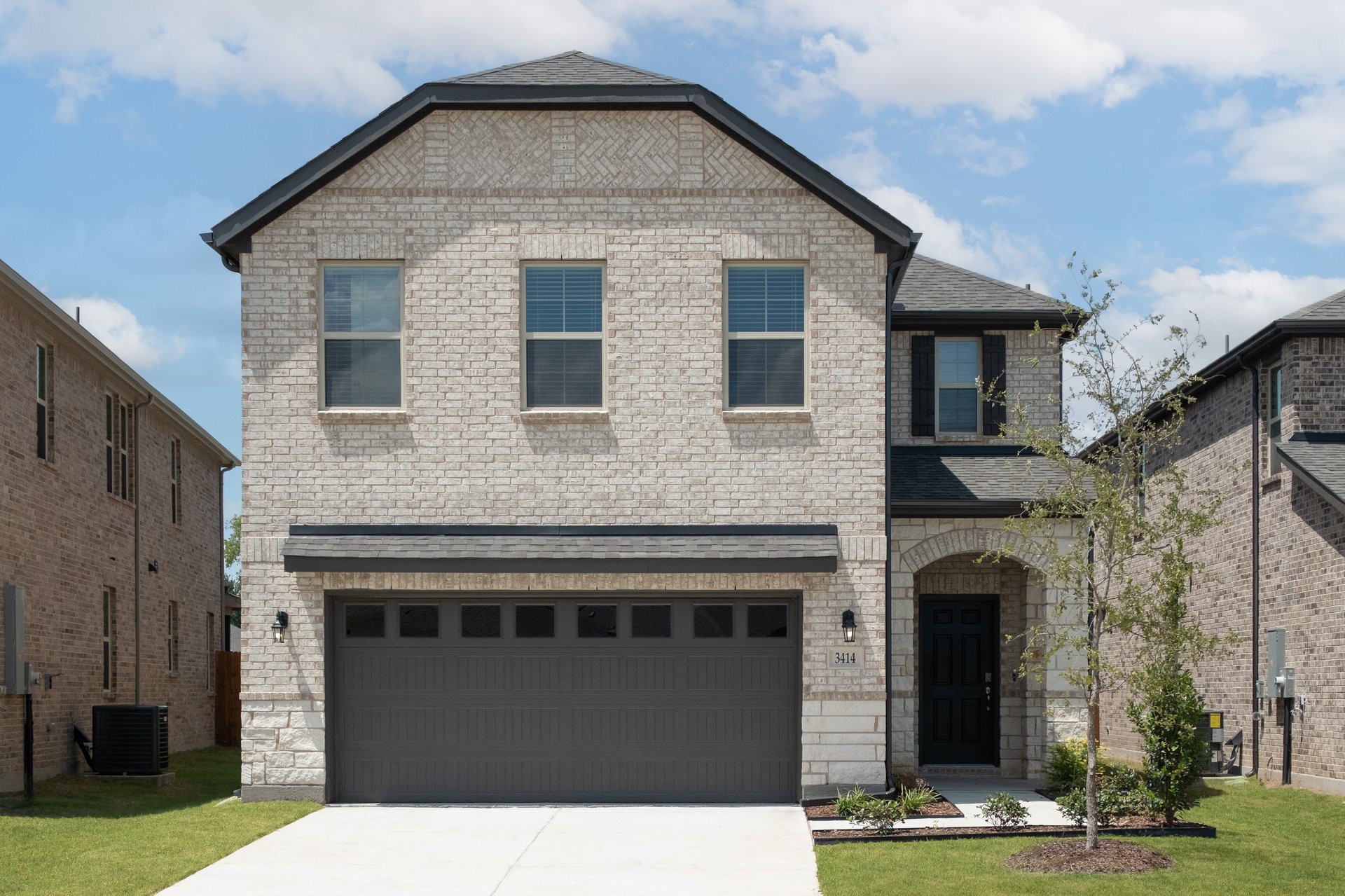 two-story home with brick and stone exterior