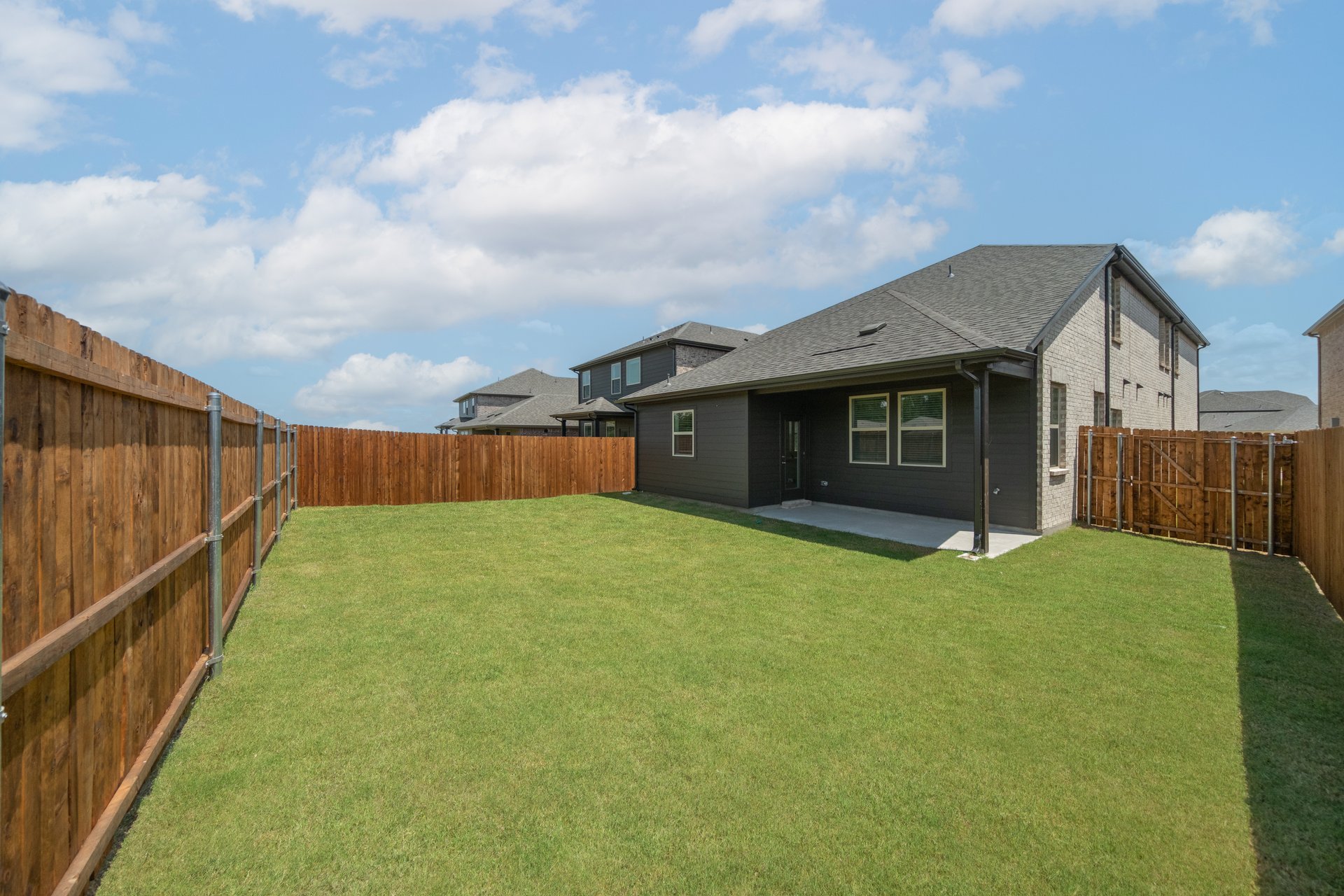 backyard with grass and covered patio