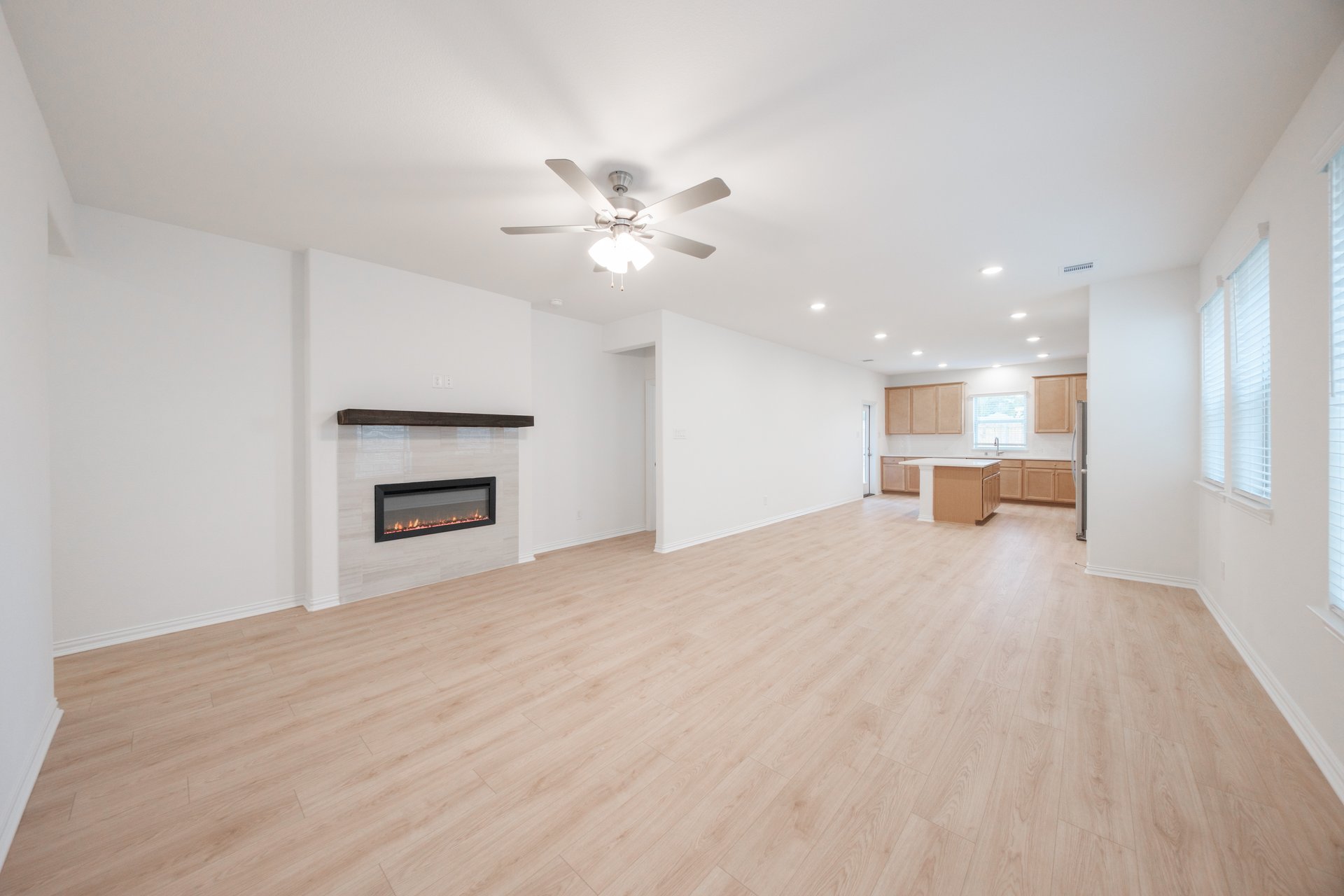 open great room with wood floors and fireplace