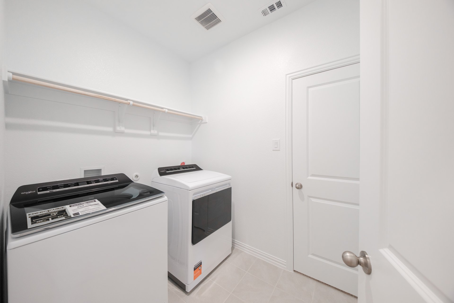 laundry room with tile floors, washer, and dryer