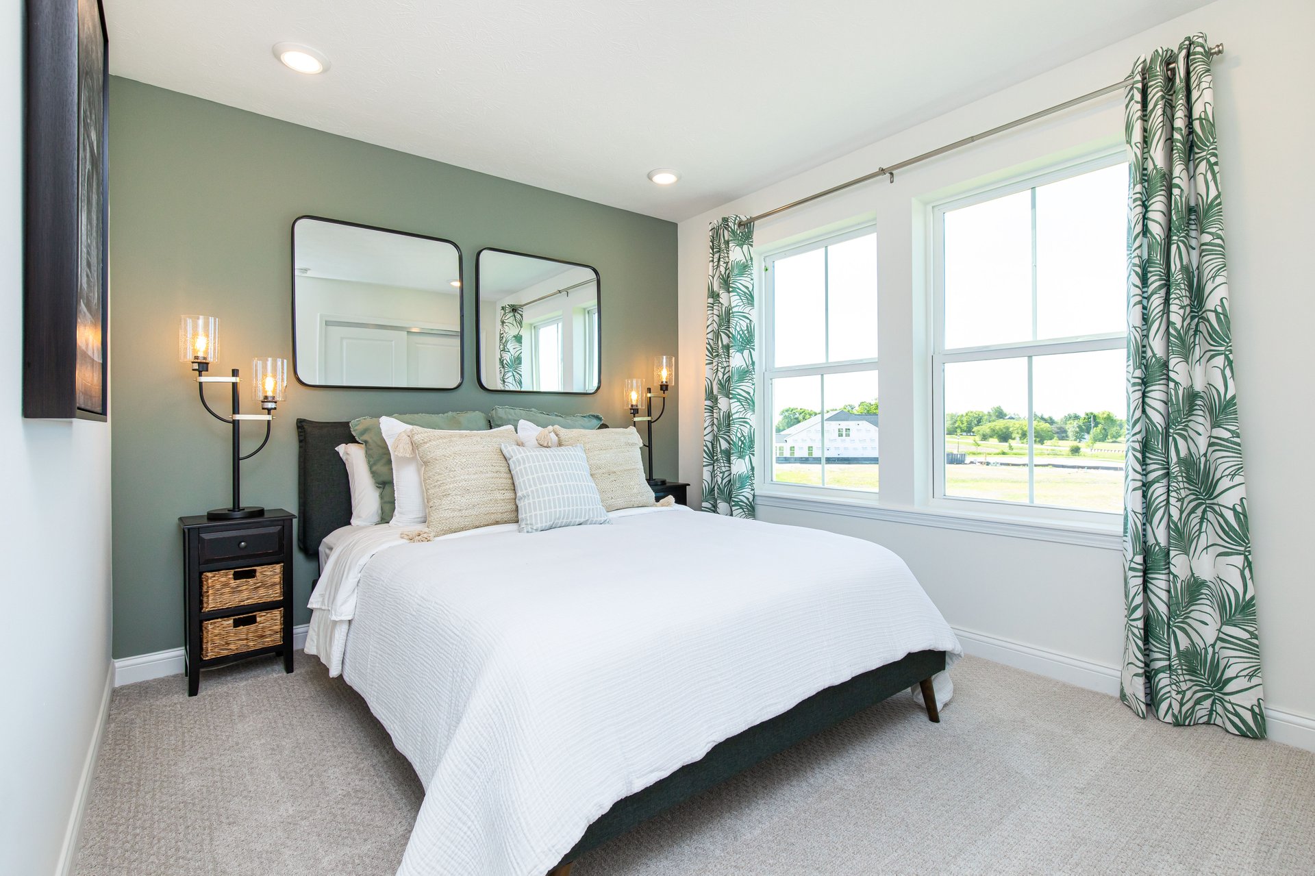 guest bedroom with green accents and decorated bed