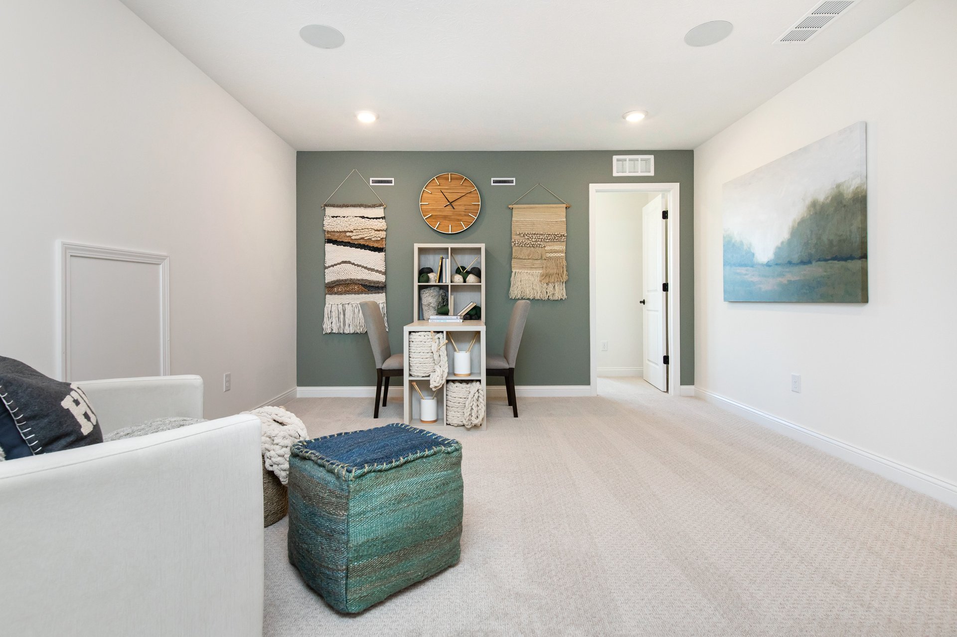 loft with green accents and an accent chair