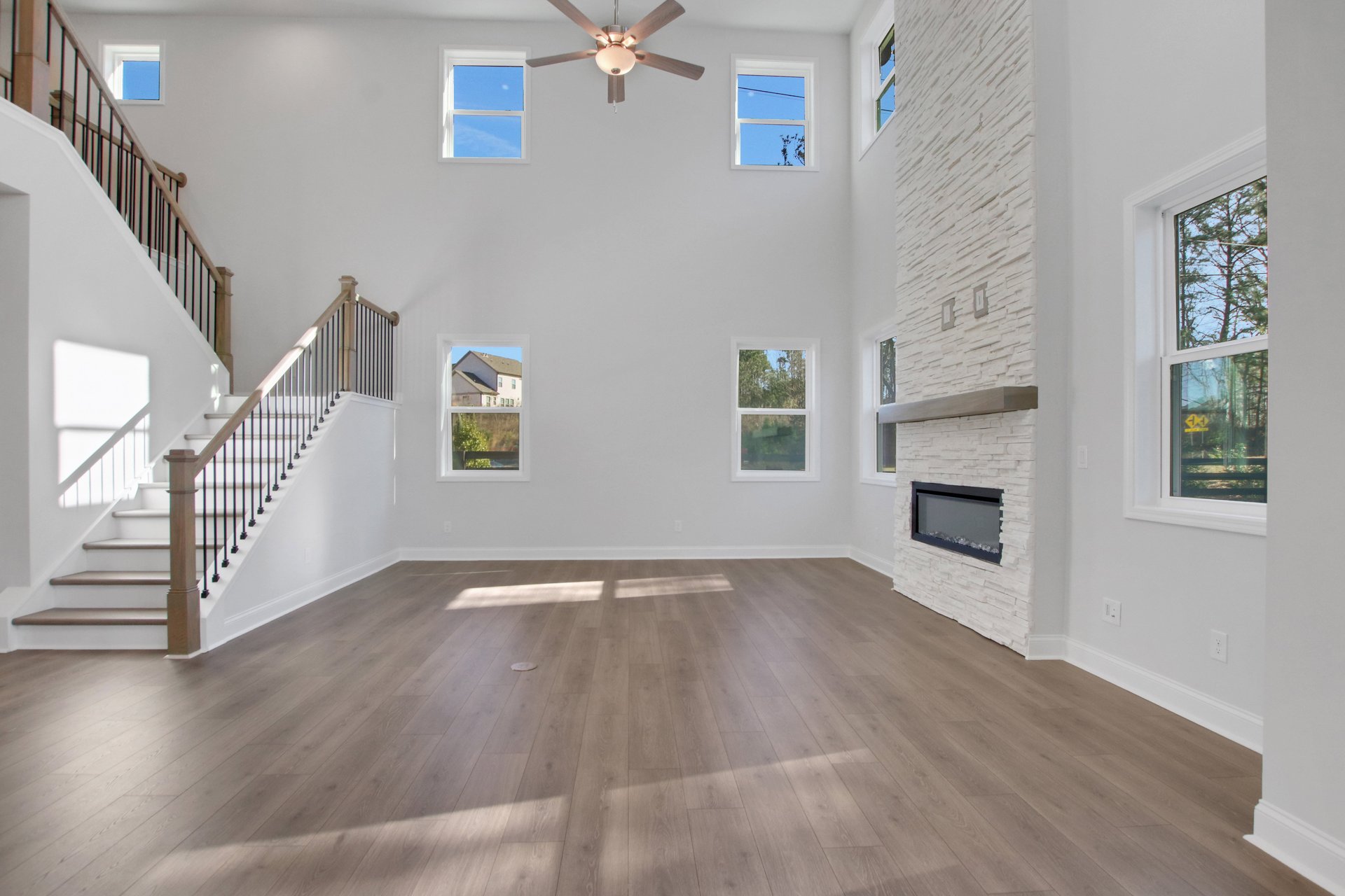 2-story great room with electric fireplace and hard surface flooring