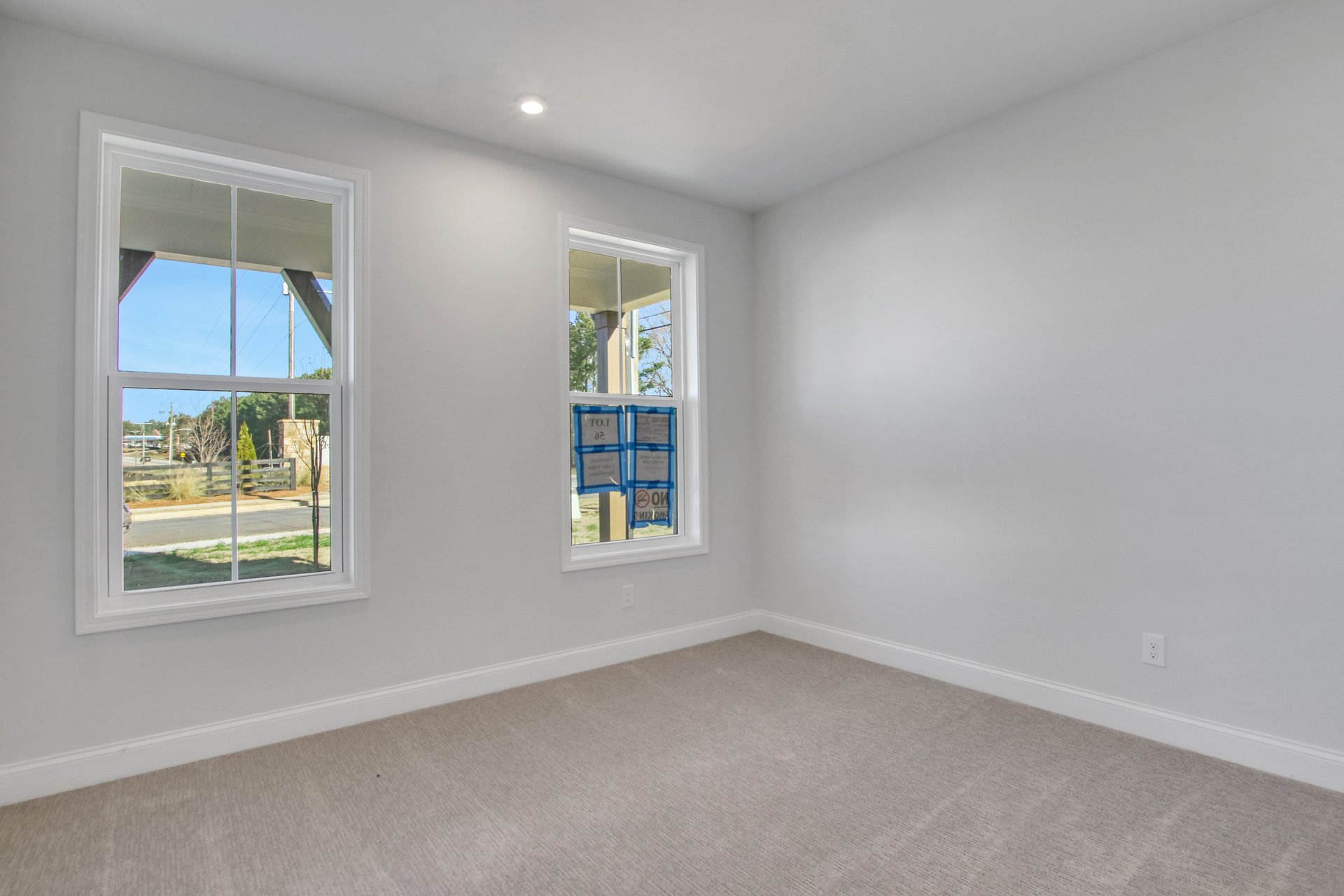 main level bedroom with windows and carpets