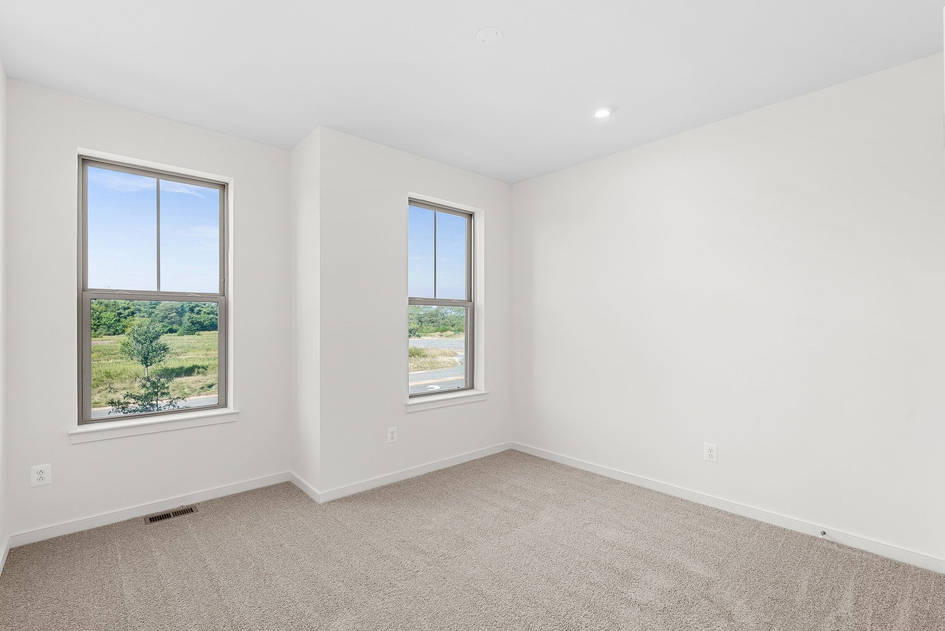 secondary bedroom with two doors to closet and hallway