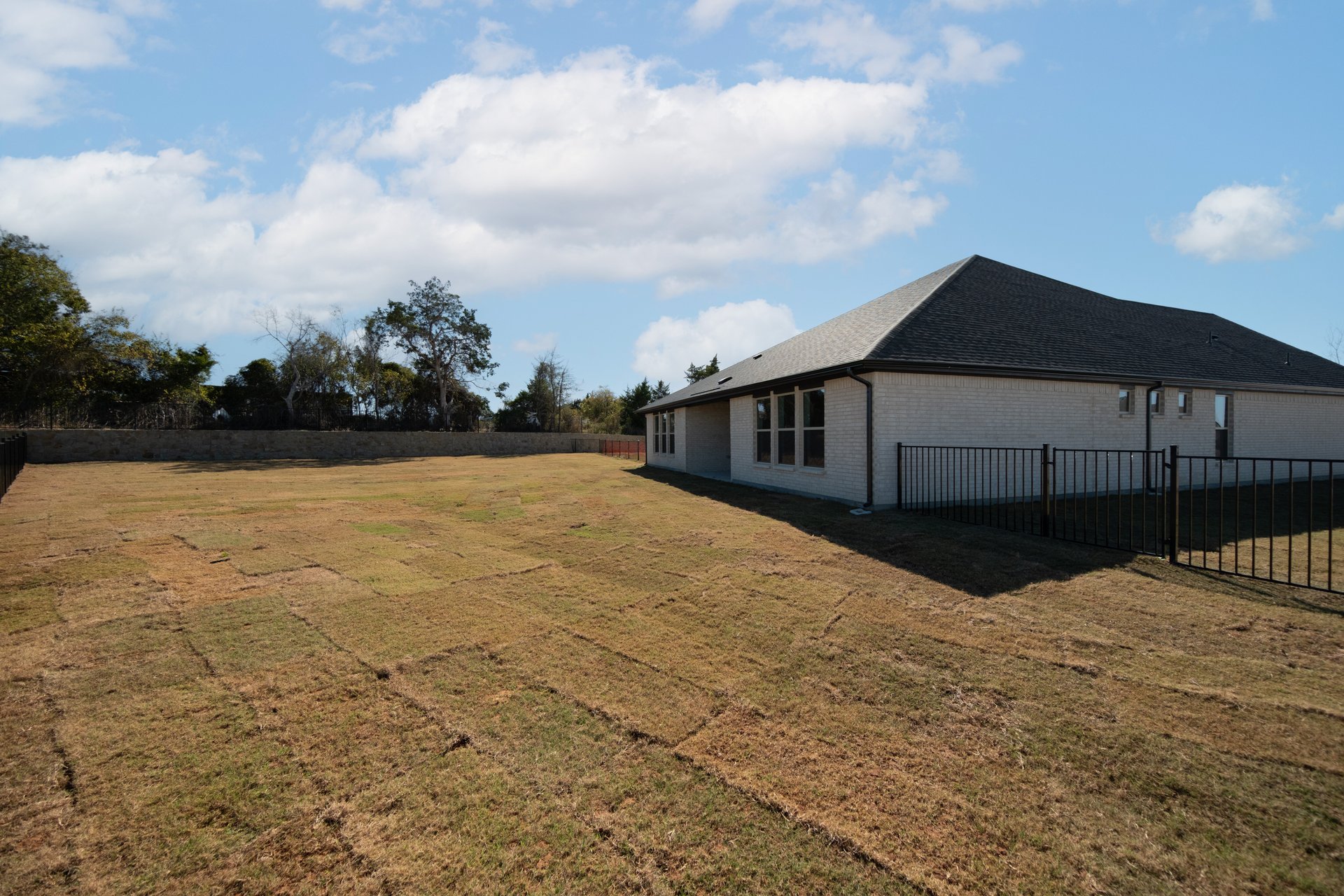 large backyard with fence and grass 